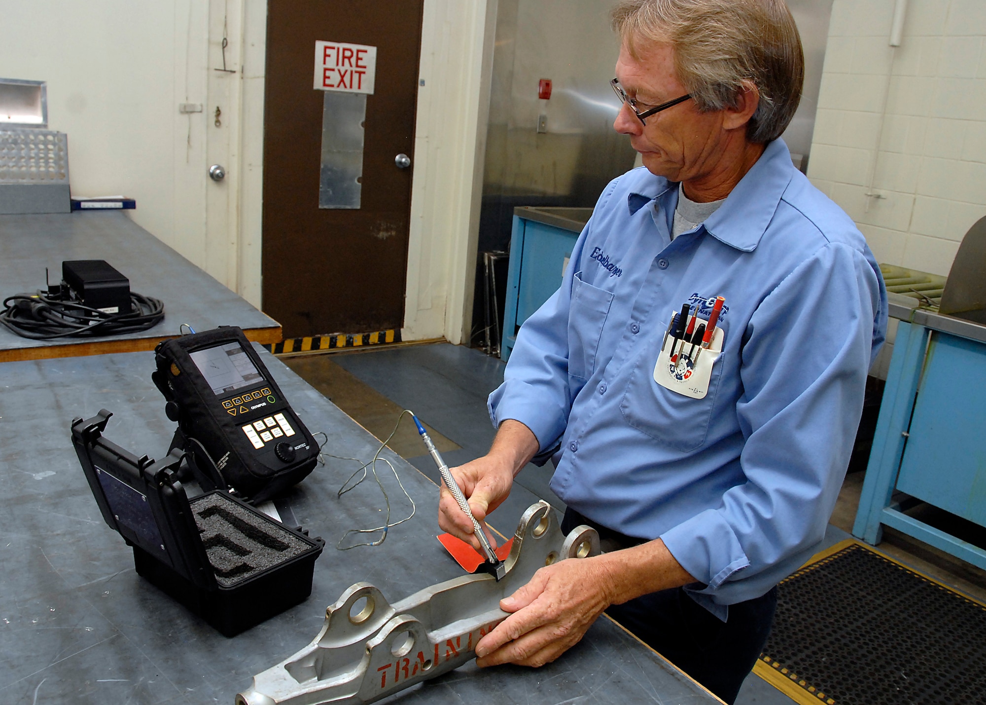 Joe Eckelbarger uses an eddy current July 26 to search for defects in an aircraft part at the 80th Flying Training Wing's Non-destructive Inspection shop. An eddy current is the outer ring of a magnetic current. Specialists such as Mr. Eckelbarger use this and four other techniques to look for defects in parts. (U.S. Air Force photo/Mike Litteken)
