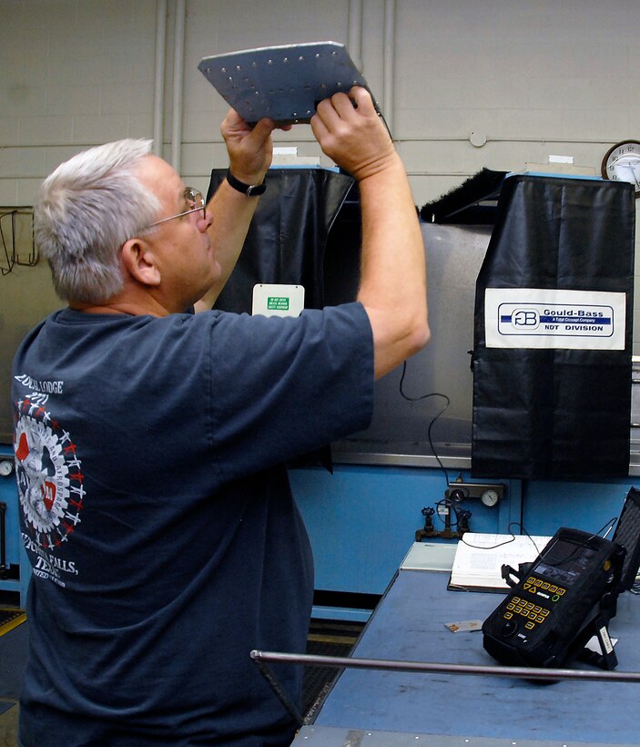 Walden Stewart, a specialist at the 80th Flying Training Wing's Non-destructive Inspection shop, uses an ultrasound machine July 26 to detect defects in a T-38C Talon part. Ultrasound is the use of sound waves that bounce off the parts and provide reading to the specialist, indicating whether or not the part is good. (U.S. Air Force photo/Mike Litteken)