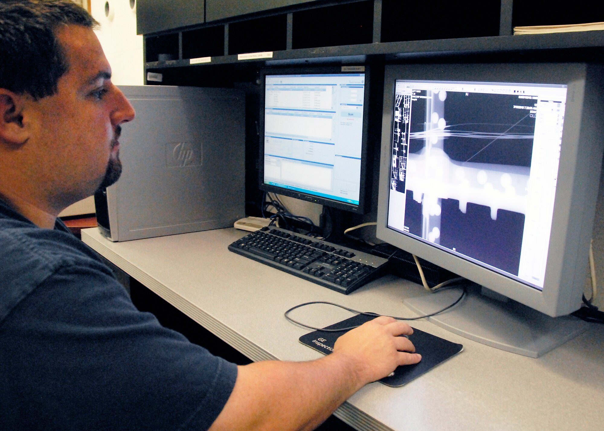 Chris Reed, a Non-destructive Inspection specialist at the 80th Flying Training Wing, reviews an X-ray July 26 during the inspection of an aircraft. X-rays give specialists in the shop the ability to locate even the smallest of cracks in airframes. (U.S. Air Force photo/Mike Litteken)