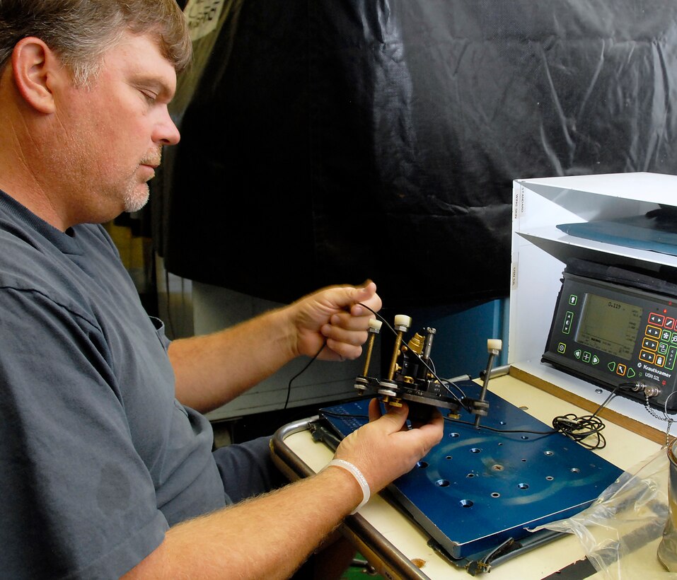 Mike Burnham, a Non-destructive Inspection specialist at the 80th Flying Training Wing, uses ultrasound conduct an ultrasonic roto scan of an aircraft part July 26 to locate any defects. The NDI shop is responsible for finding the smallest of cracks in aircraft parts as well as the airframe. (U.S. Air Force photo/Mike Litteken)