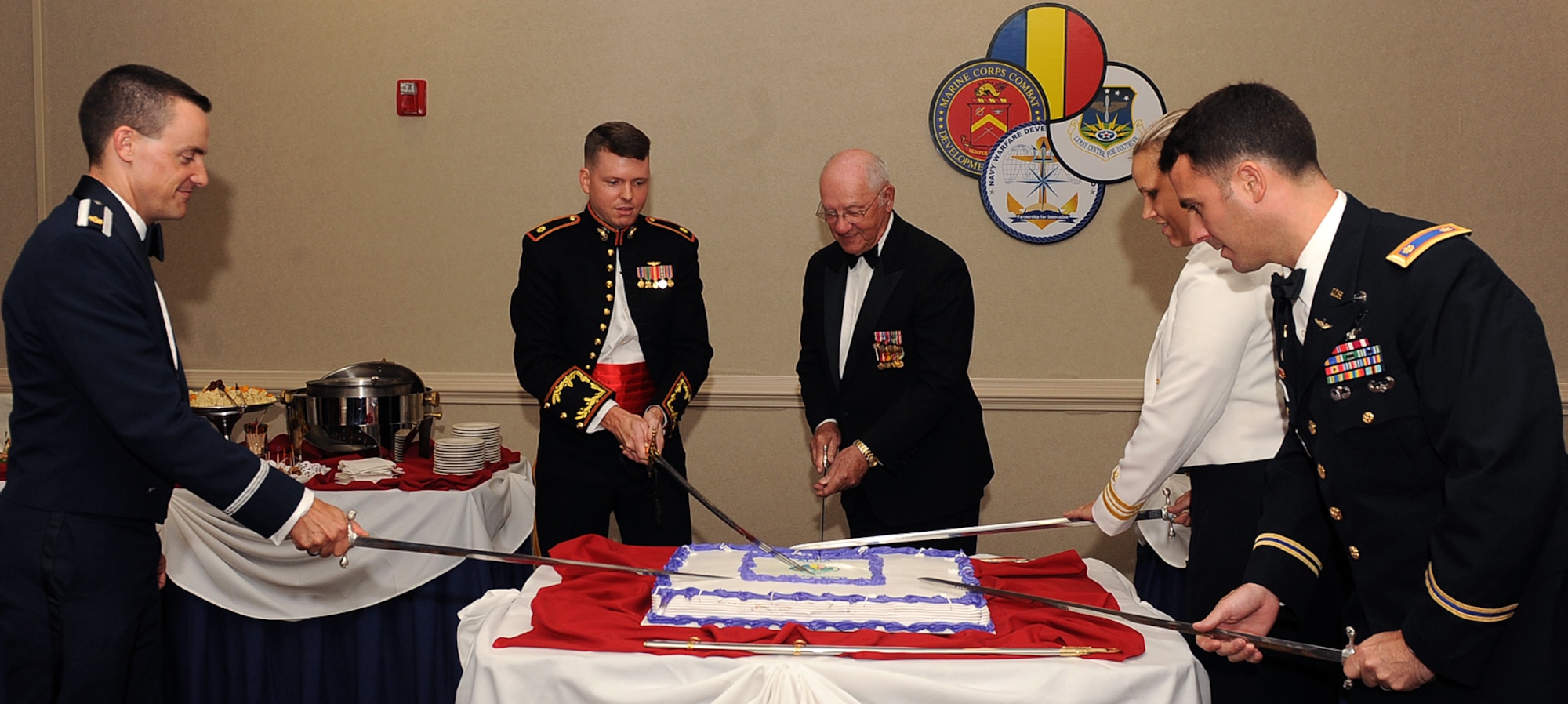 LANGLEY AIR FORCE BASE, Va. – Joint action officers of the Air, Land, Sea Applications Center, U.S. Air Force Maj. William Wallis, U.S. Marine Corps Maj. Jeffrey Hughes, retired U.S. Army Col. Gordon Lynch, U.S. Navy Lt. Cmdr. Cynthia Dieterly, U.S. Army Maj. Brian Bolio, cut a cake during the 35th anniversary of ALSA July 23. ALSA is tasked to develop multiservice tactics, techniques, and procedures to facilitate joint information exchange and operational solutions across the entire military spectrum, meeting the needs of war fighters. (U.S. Air Force photo/Senior Airman Gul Crockett)