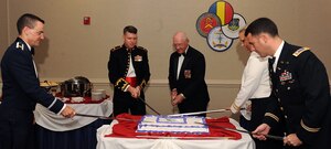 LANGLEY AIR FORCE BASE, Va. – Joint action officers of the Air, Land, Sea Applications Center, U.S. Air Force Maj. William Wallis, U.S. Marine Corps Maj. Jeffrey Hughes, retired U.S. Army Col. Gordon Lynch, U.S. Navy Lt. Cmdr. Cynthia Dieterly, U.S. Army Maj. Brian Bolio, cut a cake during the 35th anniversary of ALSA July 23. ALSA is tasked to develop multiservice tactics, techniques, and procedures to facilitate joint information exchange and operational solutions across the entire military spectrum, meeting the needs of war fighters. (U.S. Air Force photo/Senior Airman Gul Crockett)