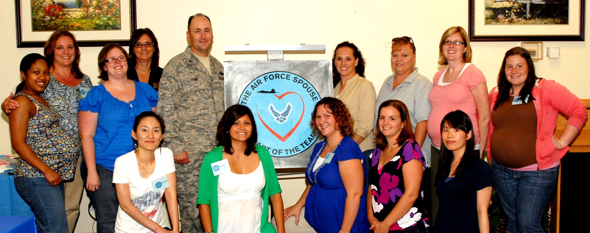 Col. Stuart Shaw, former 97th Air Mobility Wing vice commander, and spouses of the Heartlink program July 14. Each spouce received a spouse's coin. (U.S. Air Force photo / Airman 1st Class Christopher Arnold)