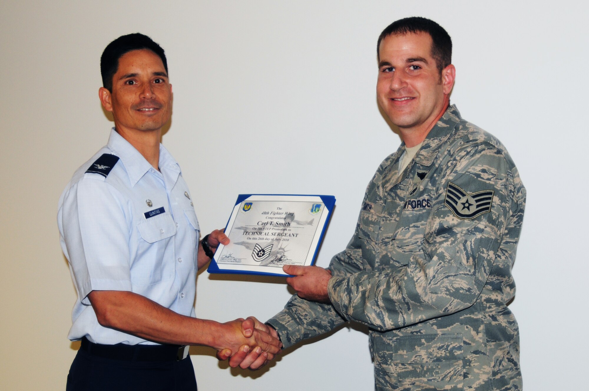Tech. Sgt. Carl Smith, 56th Rescue Squadron flight engineer, is promoted by 48th Fighter Wing Commander Col. John Quintas July 27. Sergeant Smith was promoted from staff to technical sergeant under the Stripes for Exceptional Performers (STEP) program, which instantaneously promotes individuals outside of the normal promotion cycle. (U.S. Air Force photo/Senior Airman David Dobrydney)