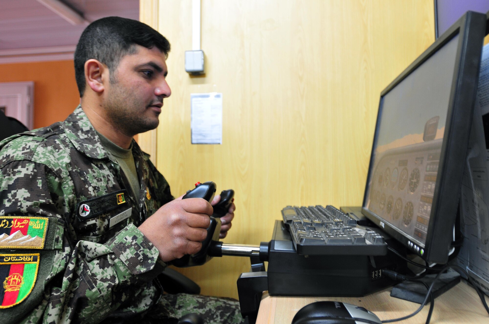 100726-N-6031Q-002 KABUL, Afghanistan - 1Lt. Ghaulam Mujtaba Saber simulates flying a Cessna 172 Skyhawk aircraft over the city of Kabul, Afghanistan during flight training conducted at the "Thunder Lab" English and cultural immersion facility on the Afghan Air Force base in Kabul on July 26, 2010. The simulator is a new feature at the "Thunder Lab" being utilized to enhance both the training experience and the proficiency of the Afghan pilot candidates. (US Navy photo by Mass Communication Specialist 2nd Class David Quillen/ RELEASED).