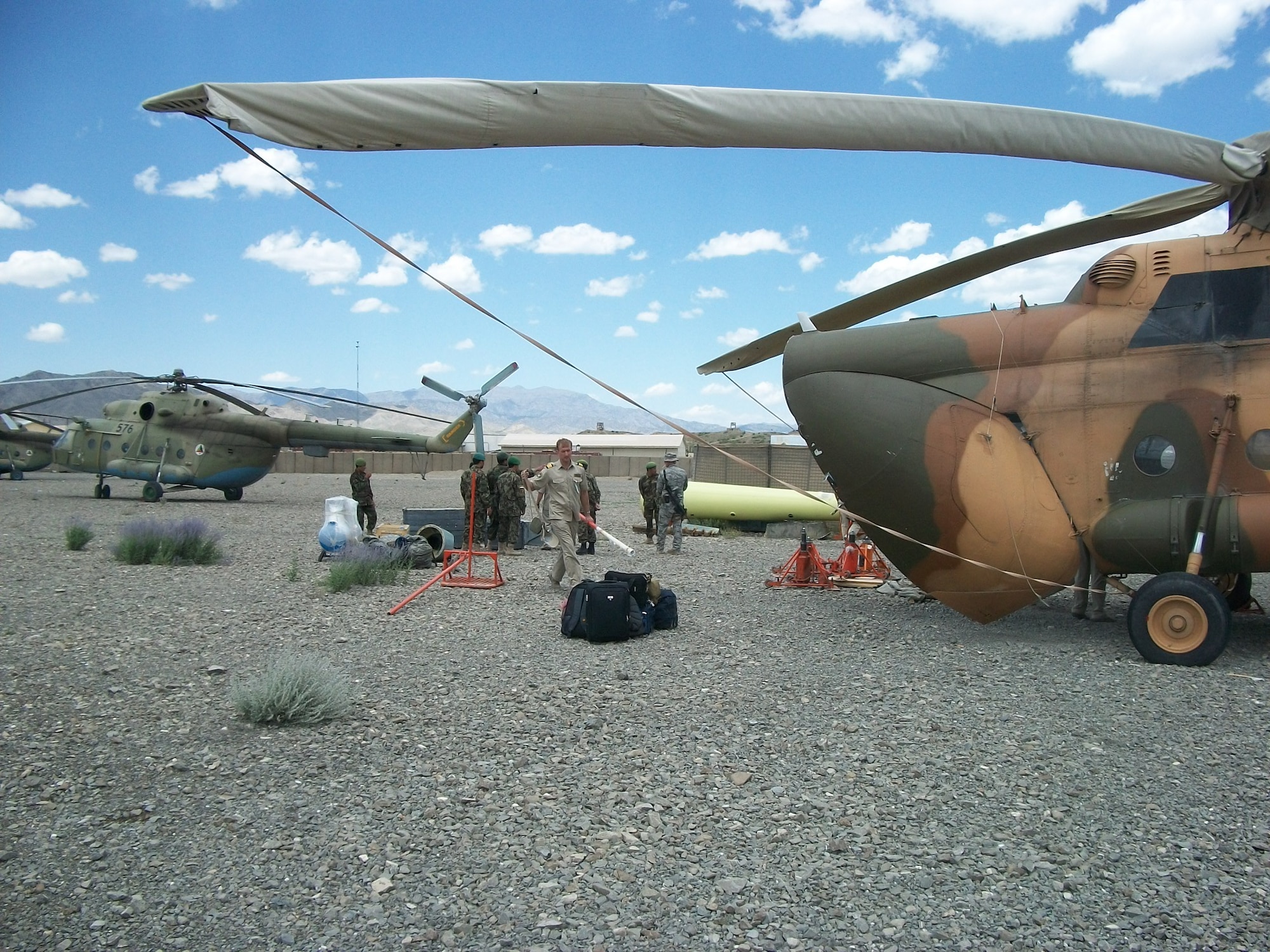 ORGUN-E, Afghanistan - A team of contractors, CAPTF mentors, and AAF maintainers replace the tailboom of Mi-17 number 594. (U.S. Military photo/RELEASED).


