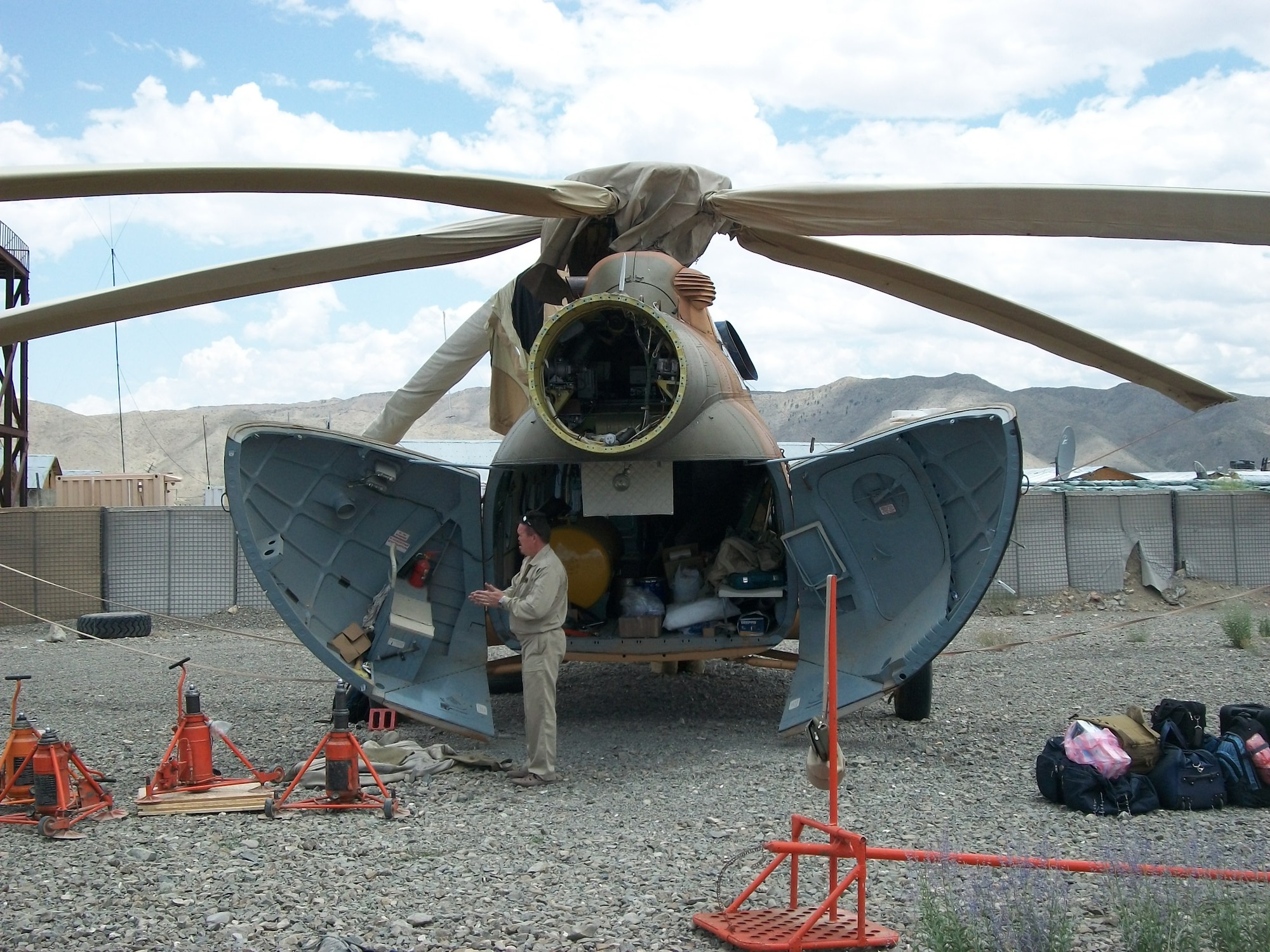 ORGUN-E, Afghanistan - A team of contractors, CAPTF mentors, and AAF maintainers replace the tailboom of Mi-17 number 594. (U.S. Military photo/RELEASED).



