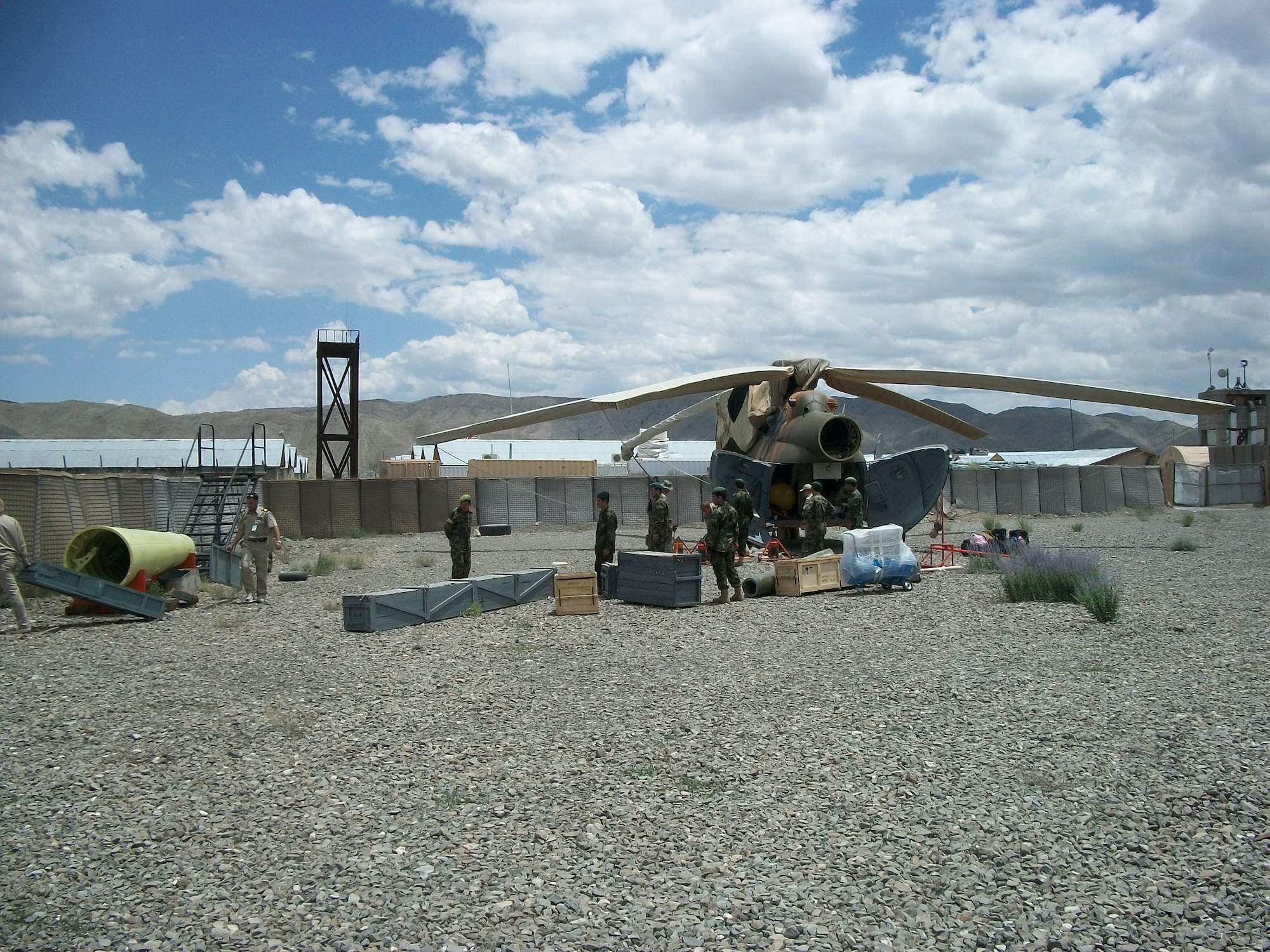 ORGUN-E, Afghanistan - A team of contractors, CAPTF mentors, and AAF maintainers replace the tailboom of Mi-17 number 594. (U.S. Military photo/RELEASED).


