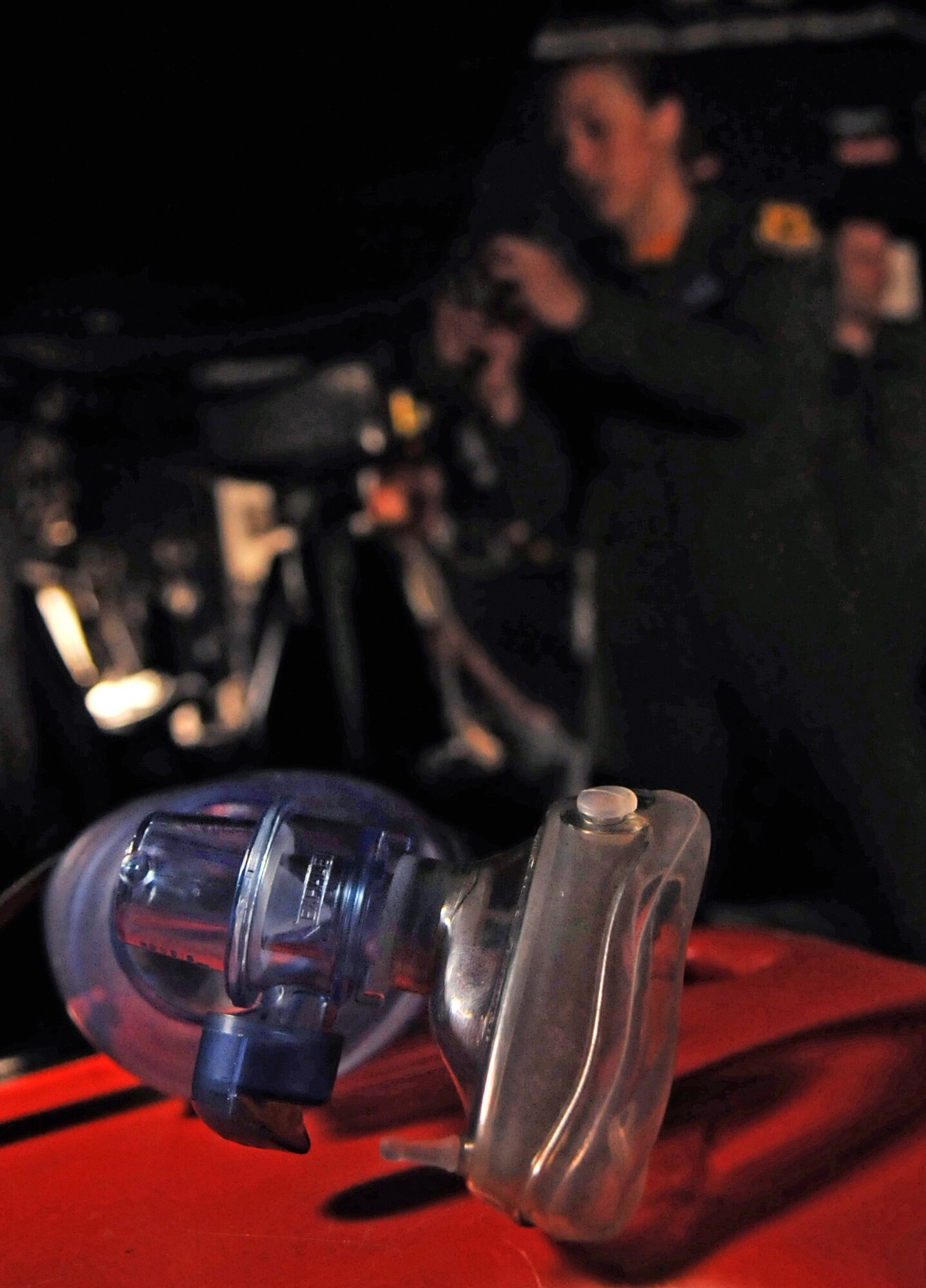 1st Lt. Alicia Blenkush, 18th Aeromedical Evacuation Squadron flight nurse, sets up equipment on a C-130 prior to a visit from 30 Japan Air Self Defense Force airmen as part of a two-day aerovac knowledge exchange July 22-23. Airmen from the 18th AES visited Naha Air Base July 22 to learn about Japan's "Kido-Eisei" intensive care unit and its evolving mission. (U.S. Air Force photo/Staff Sgt. Jason Lake)
