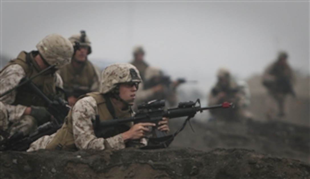 U.S. Marines from Special Purpose Marine Air-Ground Task Force 24 raid a building during a multinational amphibious beach assault training exercise in Ancon, Peru, on July 19, 2010.  The Marines were deployed in support of operation Partnership of the Americas/Southern Exchange, a combined amphibious exercise with maritime forces from Argentina, Mexico, Peru, Brazil, Uruguay and Colombia.  