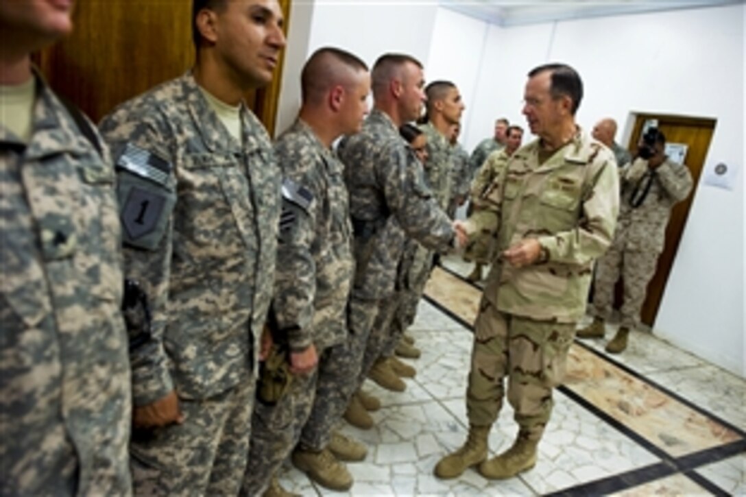 U.S. Navy Adm. Mike Mullen, chairman of the Joint Chiefs of Staff, greets troops assigned to the Combined Press Information Center in Baghdad, July 27, 2010. Mullen's final stop in Iraq wraps up a 10-day trip around the world.




