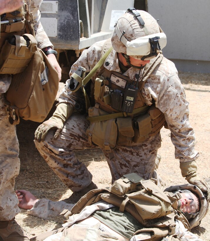 Staff Sgt. Daniel P. Blackwell from 3rd Battalion, 25th Marine Regiment, 4th Marine Division, treats a mock casualty after a simulated suicide attack at Camp Pendleton, Calif., July 27, 2010.  Blackwell and his Marines 1st Platoon, Company L, treated five mock casualties caused by a simulated vehicle explosion while they awaited a helicopter to transport the victims.