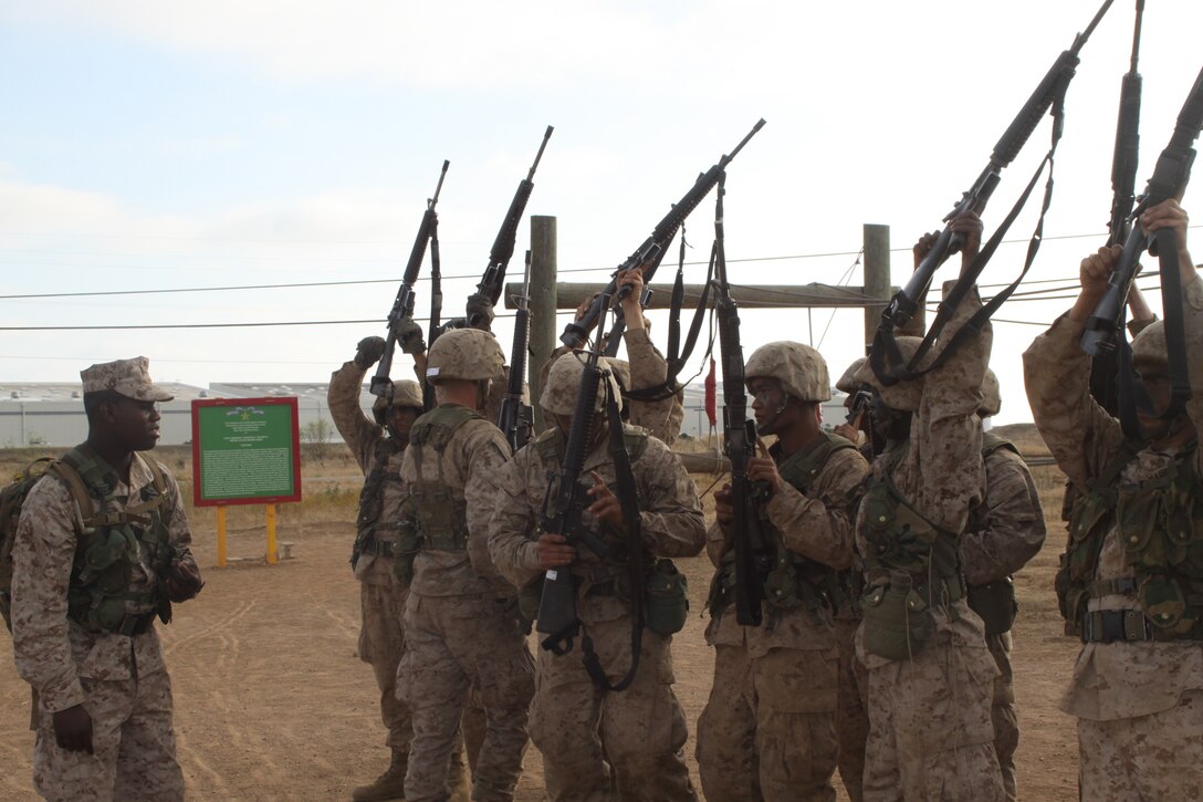 Recruits from Platoon 3275, Company M counting off their rifles after completing the Confidence Course on the Crucible.