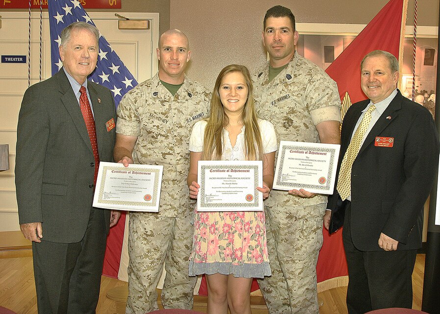 Colonel Nate Smith Scholarship recipients and family members present their Certificates of Achievement at the Marine Corps Recruit Depot Museum Historical Society's Quartley Breakfast at the Visitor's Reception Center in the Depot Museum, July 27.