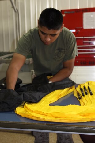 Cpl. Jose J. Hernandez, flight equipment technician prepares life preservers at Marine Aviation Logistics 12 Aviation Life Support here July 27. Some of the life support equipment includes parachutes, oxygen systems and several different survival items in case of a condition in which the pilot could not survive.