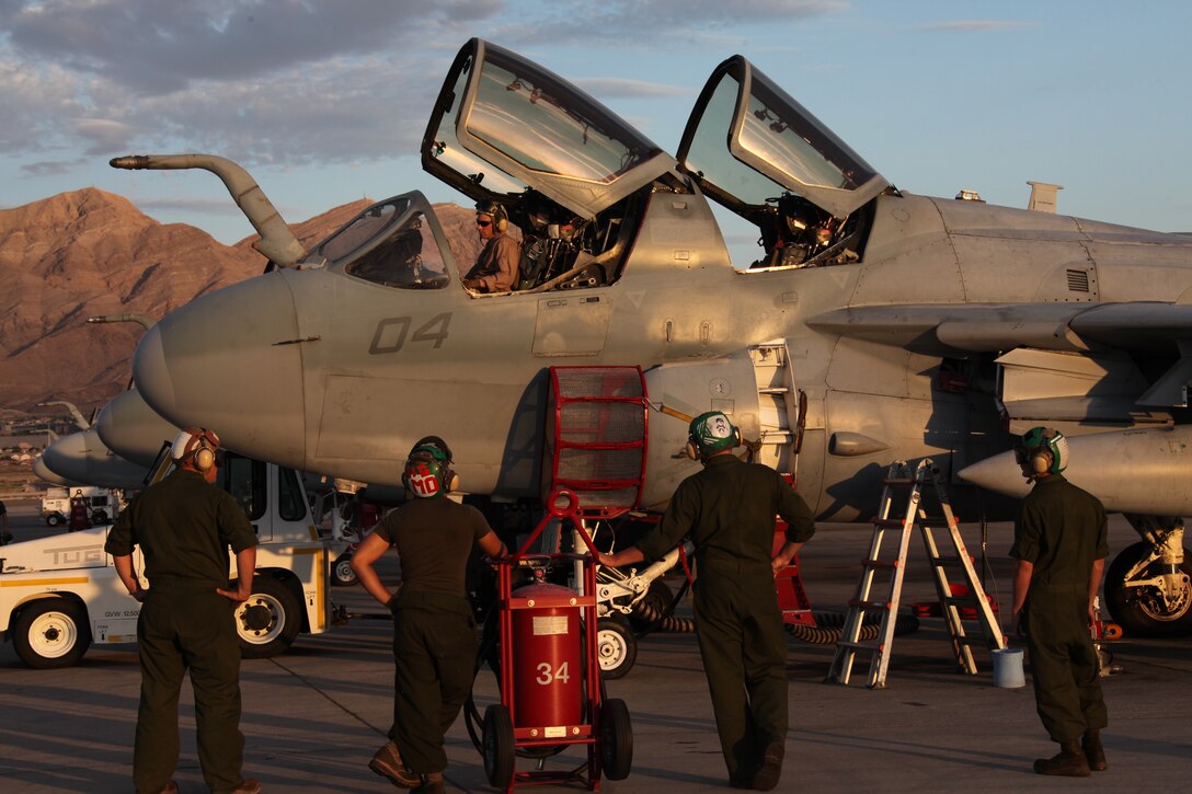 Maintenance Marines, of Marine Tactical Electronic Warfare Squadron 3, standing by for an aircraft inspection on an EA-6B Prowler at Nellis Air Force Base, Nev., July 28. (Left to Right) Sgt. Norman W. Hinman, powerline mechanic with VMAQ-3, and VMAQ-3 airframe mechanics – Cpl. Yezid A. Morales, Cpl. Kasey L. Gehman, Lance Cpl. Julian Chaparro.