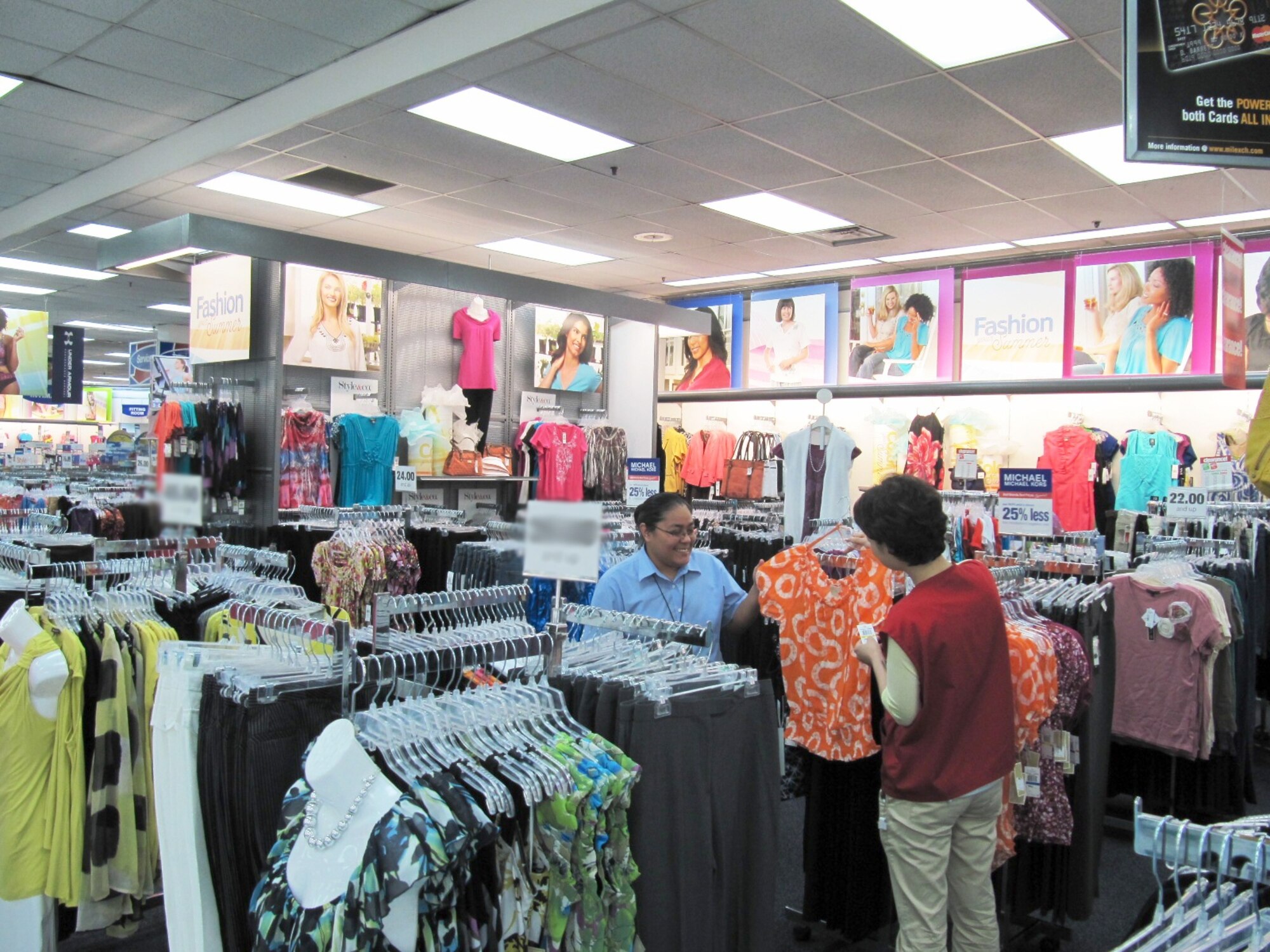 YONGSAN GARRISON, Republic of Korea -- Sales associate Chong-Chi Yong (right) assists customer, Tessie Asanoma, with a blouse in the women’s clothing section of the Yongsan Post Exchange July 14. The Yongsan PX will soon be expanding its line of women’s clothing with name brands that reflect the latest fashion trends. (Photo courtesy of Stan Young, Yongsan Garrison Post Exchange)