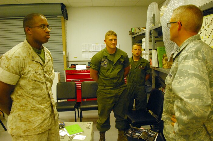 NELLIS AIR FORCE BASE, Nev. -- Lance Cpls. Joshua McCray, quality assuance, and Garrett Chapman, ground support equipment, and Sgt. Gerry Evans, avionics ordinance technician, from Marine Tactical Electronic Warfare Squadron 3, Cherry Point, N.C. talk with Chaplain (Capt.) David Knight, 20th Fighter Wing and Air Expeditionary Wing chaplain at Red Flag 10-4 July 27, 2010. The chaplain team went around to the various units here during Red Flag passing out drinks and popsicles and chatting with the troops to help boost morale. (U.S. Air Force photo by Airman 1st Class Daniel Phelps)