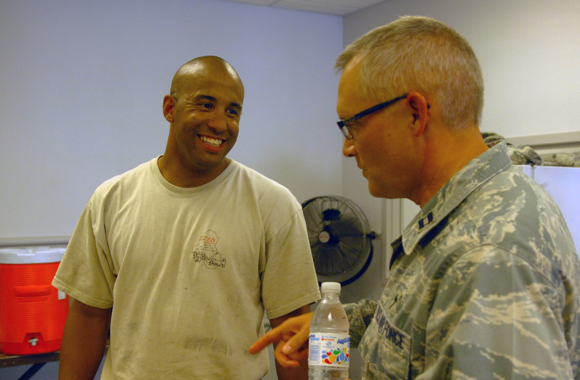 NELLIS AIR FORCE BASE, Nev. -- Chaplain (Capt.) David Knight, 20th Fighter Wing and Air Expeditionary Wing chaplain, talks with Airman 1st Class Garrett Clark, 77th Aircraft Maintenance Unit, at Red Flag 10-4 July 27, 2010.The chaplain team went around to the various units here during Red Flag passing out drinks and popsicles and chatting with the troops to help boost morale. (U.S. Air Force photo by Airman 1st Class Daniel Phelps)