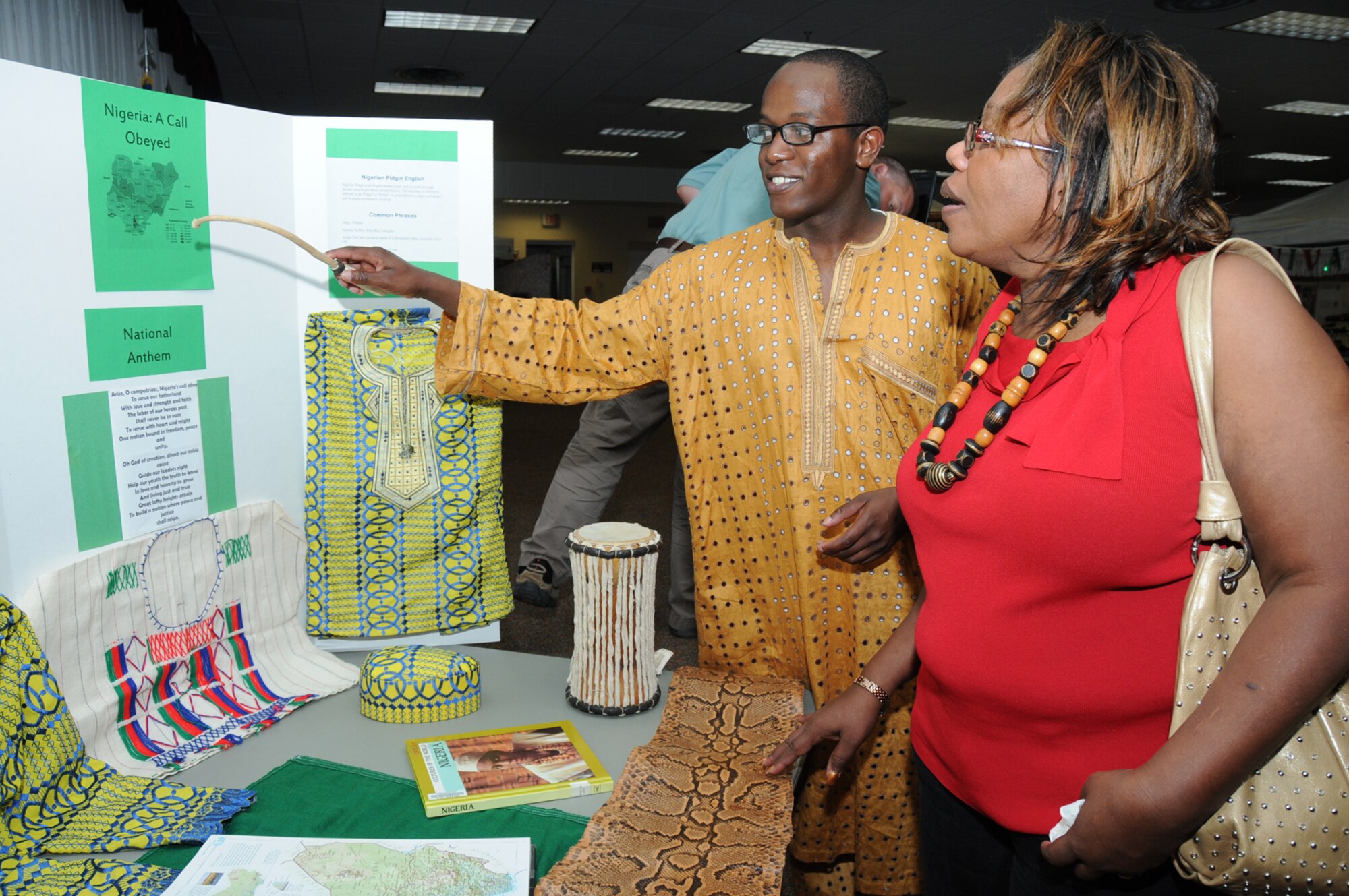 Airman 1st Class Adelumola Ajibola, 81st Comptroller Squadron, shows Arleen Stewart a map of Nigeria during Diversity Day, July 20 at the Dragon's Lair.  (U.S. Air Force photo by Kemberly Groue)