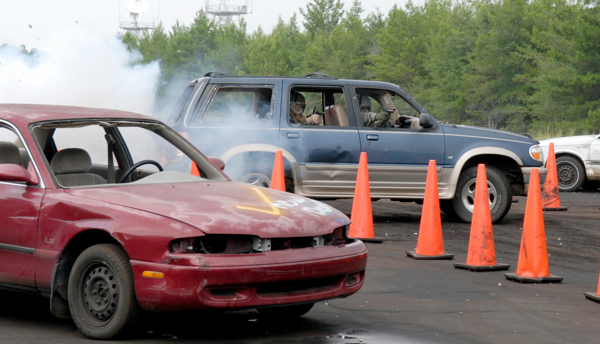 Students maneuver through the driving course while undertaking smoke bombs and simulated rounds. The course is part of a defensive driving training exercise at Eglin Range, Fla., July 23, 2010. (U.S. Air Force photo/Staff Sgt. Sarah Martinez)