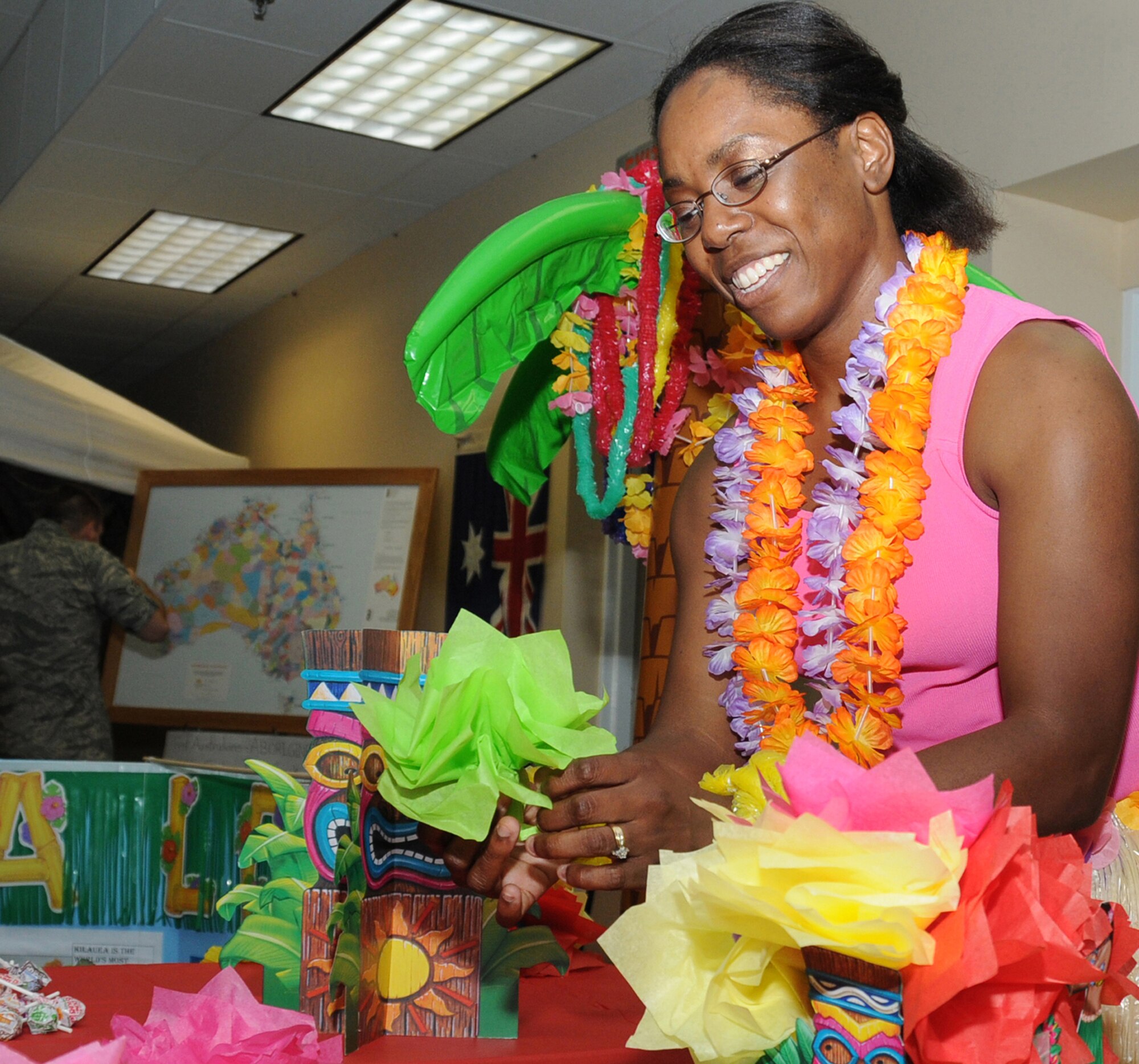 Tech. Sgt. Iya Foster, 334th Training Squadron, decorates the Hawaiian table at Diversity Day, July 20 at the Dragon’s Lair.  The event included music, literature, dance, poetry, face painting, games and food for children and adults.  The event was a celebration of many nations to promote inclusiveness and to bring Keesler closer as a community, according to Staff Sgt. Adrienne Russell-George from the 81st Training Wing’s equal opportunity office, organizer of the observance.  (U.S. Air Force photo by Kemberly Groue)