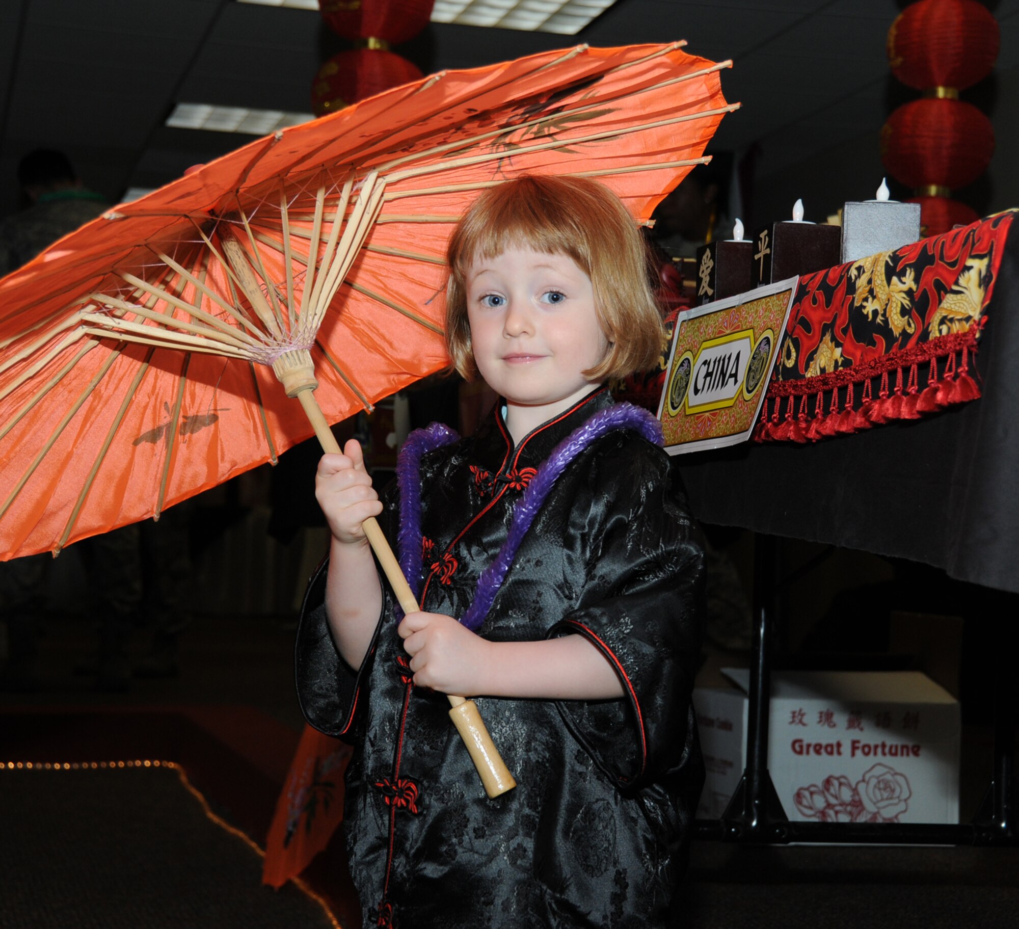 Two year-old Alexandra Carroll, daughter of Tech. Sgt. Robert and Laura Carroll, 336th Training Squadron, twirls a silk parasol and plays dress-up in traditional Chinese attire.  (U.S. Air Force photo by Kemberly Groue)