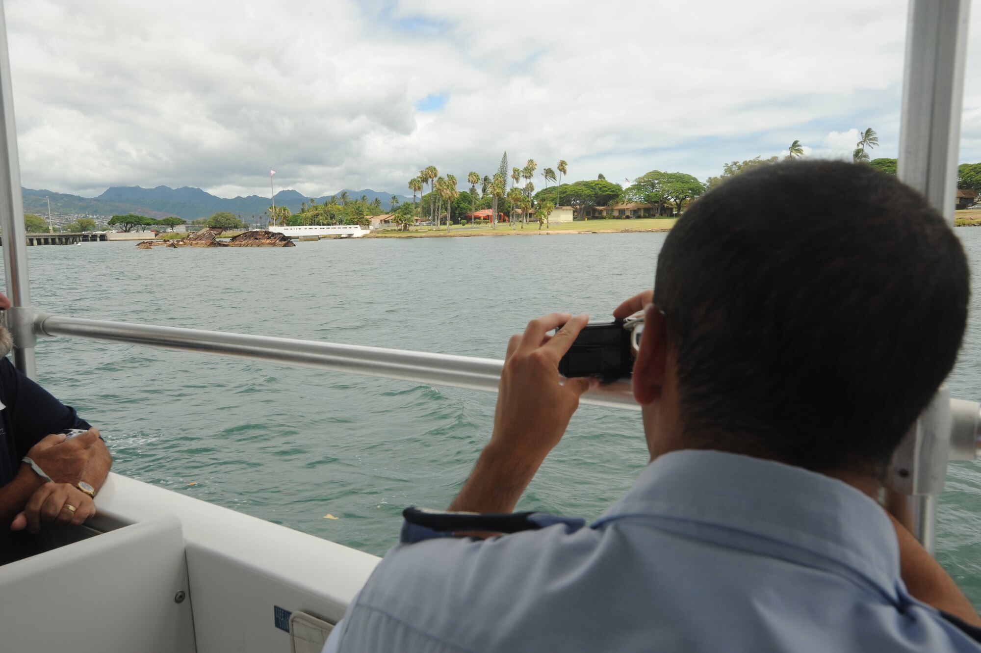 JOINT BASE PEARL HARBOR HICKAM, Hawaii - Louis Bloom, Air Force Academy cadet, takes a photo of the sunken U.S.S. Utah during the Boathouse Tour as part of Operation Air Force here, July 15. The 15th Wing mission mentor program involved time spent with the 15th Medical Group, 15th Operations Group, 15th Maintenance Group, and 647th Air Base Group to gain an appreciation for the team effort required to accomplish the 15th WG mission. Additionally, the cadets took special tours of the 613th Air and Space Operations Center and Arizona Memorial, and were included in senior officer visits. (U.S. Air Force photo/Senior Airman Gustavo Gonzalez)