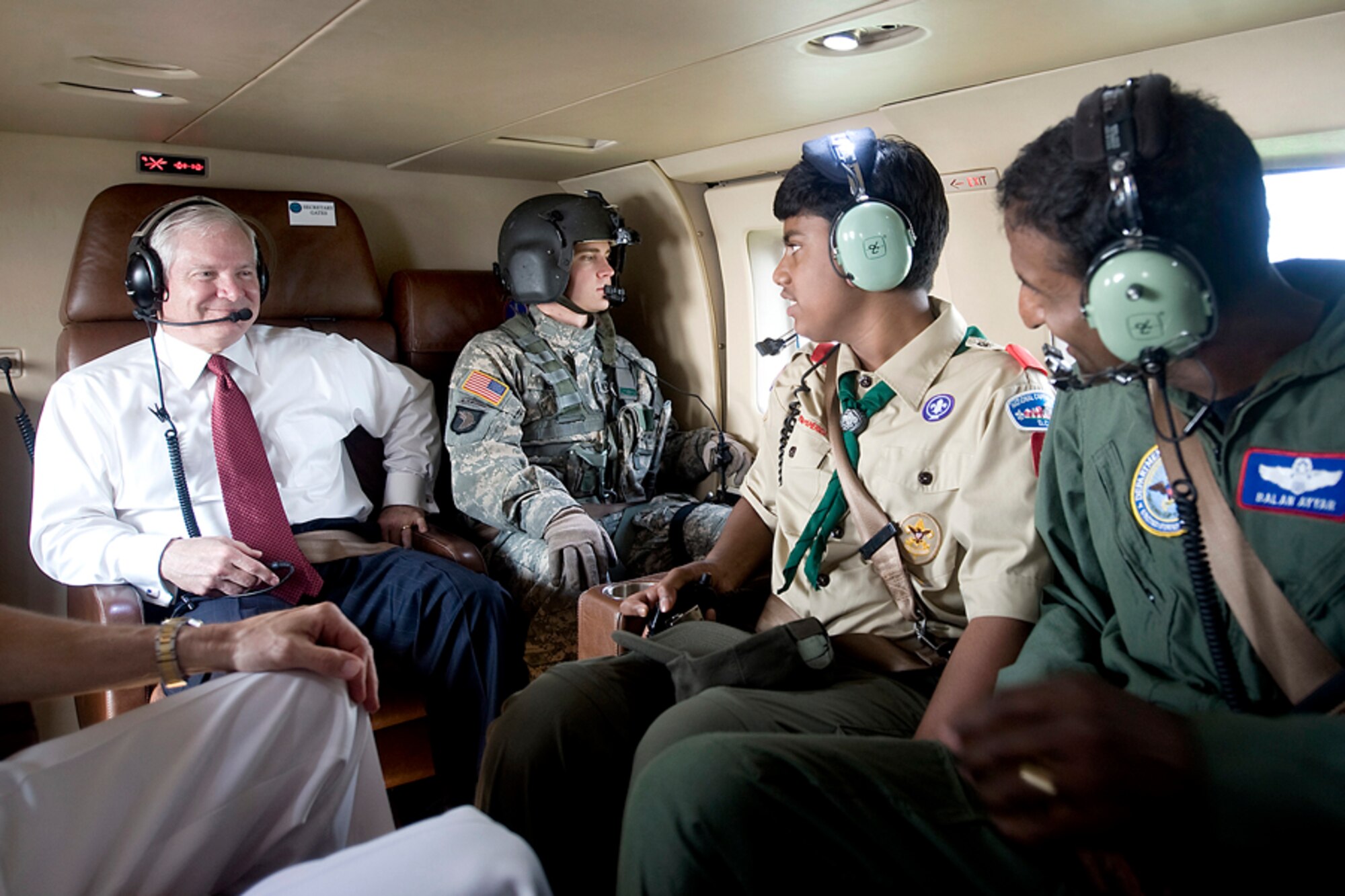 Defense Secretary Robert M. Gates chats with Boy Scout Vanas Ayyar and his father, Air Force Col. Balan Ayyar, on board a helicopter flying to the 2010 National Boy Scout Jamboree at Ft. AP Hill, Va., July 28, 2010.  The massive group of Boy Scouts from throughout the United States came to the 12,000-acre site for 10 days to celebrate the organization's 100-year anniversary.  (Defense Department photo/Cherie Cullen)