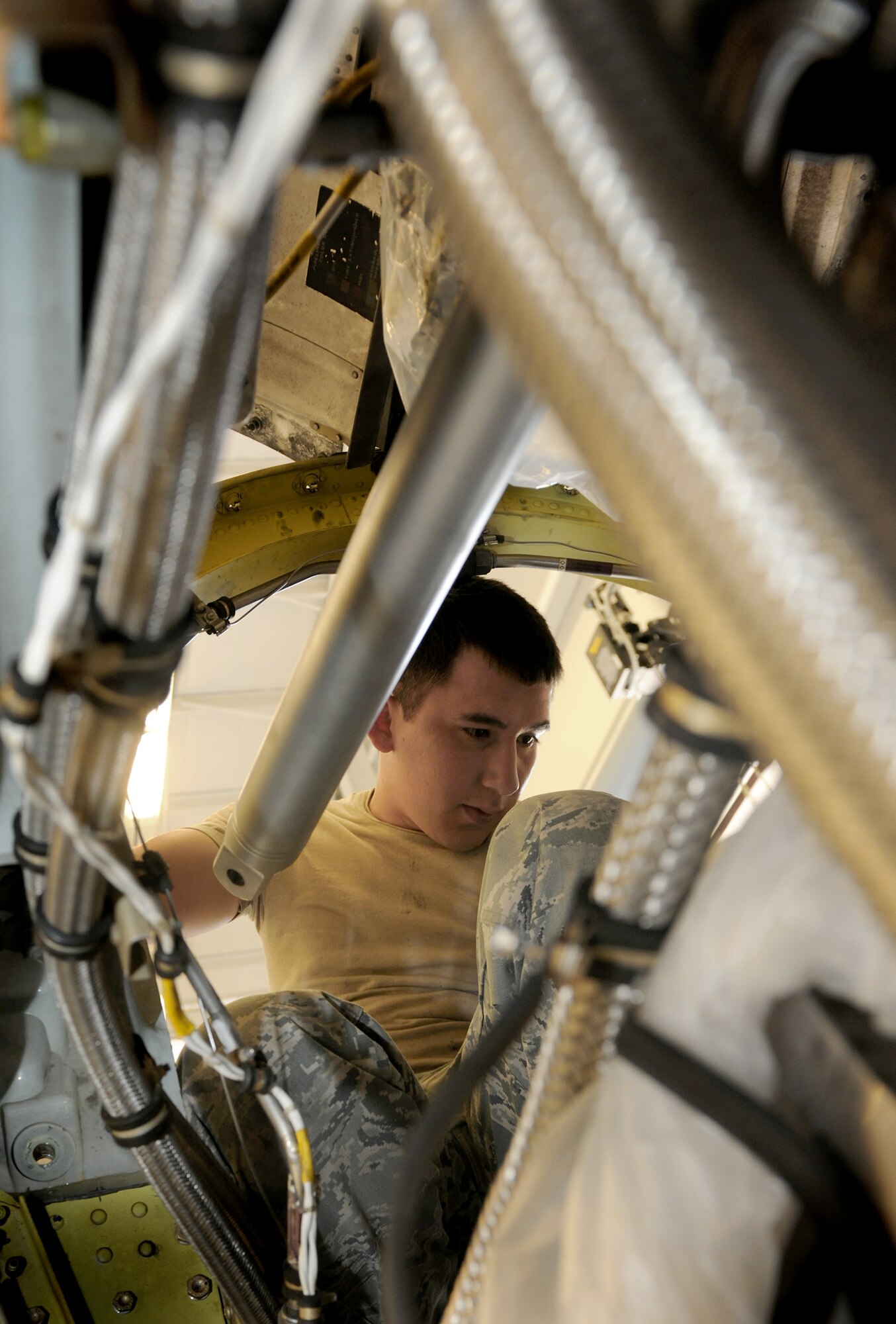 Airman 1st Class Bobby Rodriguez sits in the back of an engine from an HC-130P/N King and prepares to install a reduction gearbox July 22, 2010, at Moody Air Force Base, Ga. Airman Rodriguez is a 23rd Component Maintenance Squadron aerospace propulsion apprentice. (U.S. Air Force photo/Airman 1st Class Benjamin Wiseman)