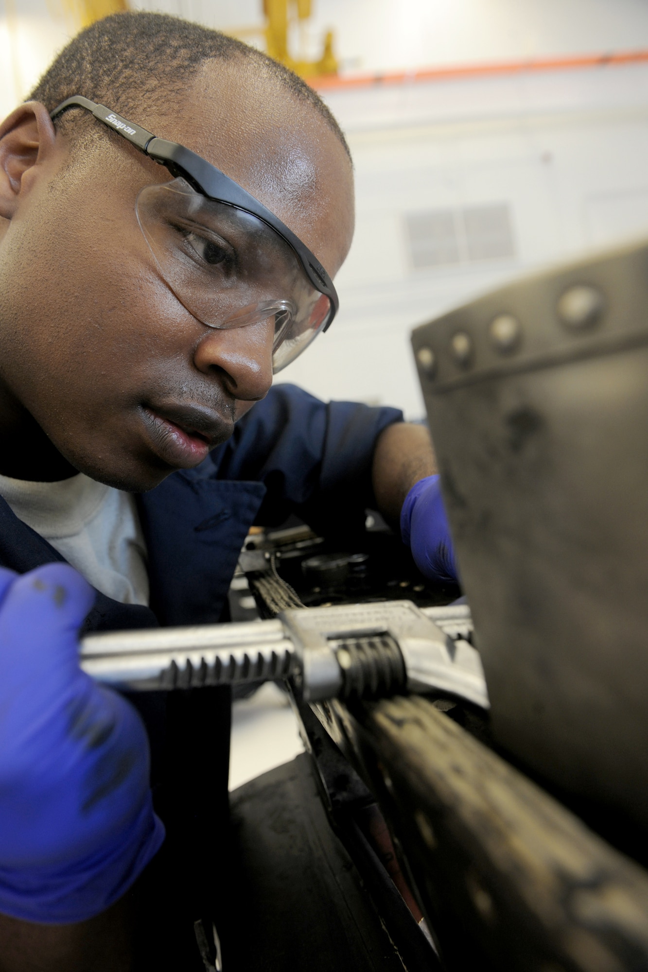Airman 1st Class Tavaris Brown uses a set of pliers to remove safety wires from an A-10C Thunderbolt II pylon tower during maintenance on a TF-34 aircraft engine July 22, 2010, at Moody Air Force Base, Ga. Once the integration is completed, each aerospace propulsion technician from the base will be able to maintain the engines of the A-10C, HC-130 P/N King and HH-60G Pave Hawk aircraft. Airman Brown is a 23rd Component Maintenance Squadron aerospace propulsion apprentice. (U.S. Air Force photo/Airman 1st Class Benjamin Wiseman)