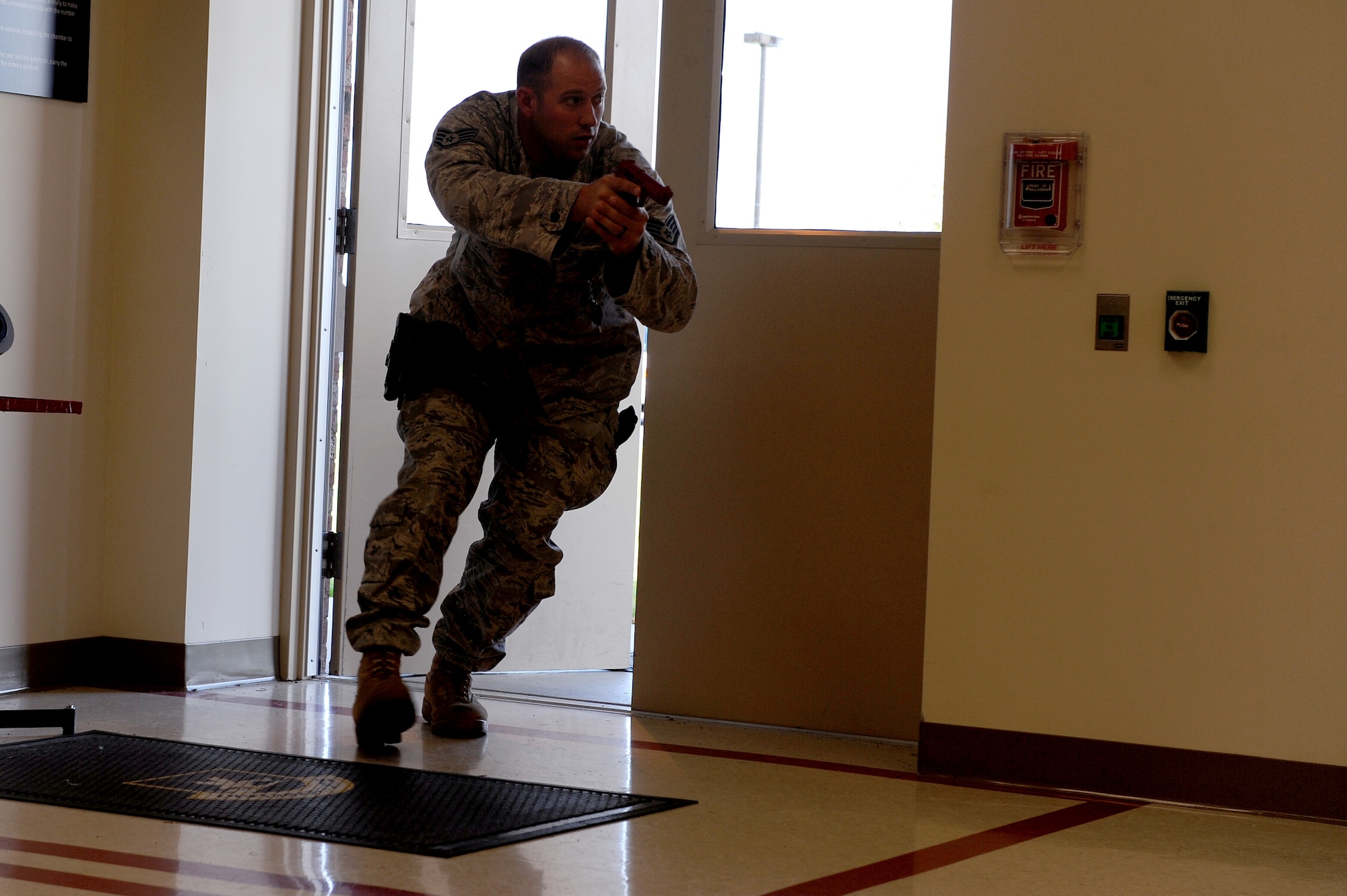 SCOTT AIR FORCE BASE, Ill. -- Staff Sgt. Jeremy Parthemore, 375th Security Forces Squadron, enters a  simulated disturbance scene during a training exercise at Scott.  Sergeant Parthemore was the first of his four man team to enter and clear the room.(U.S. Air Force Photo by Staff Sgt. Brian J. Ellis)
