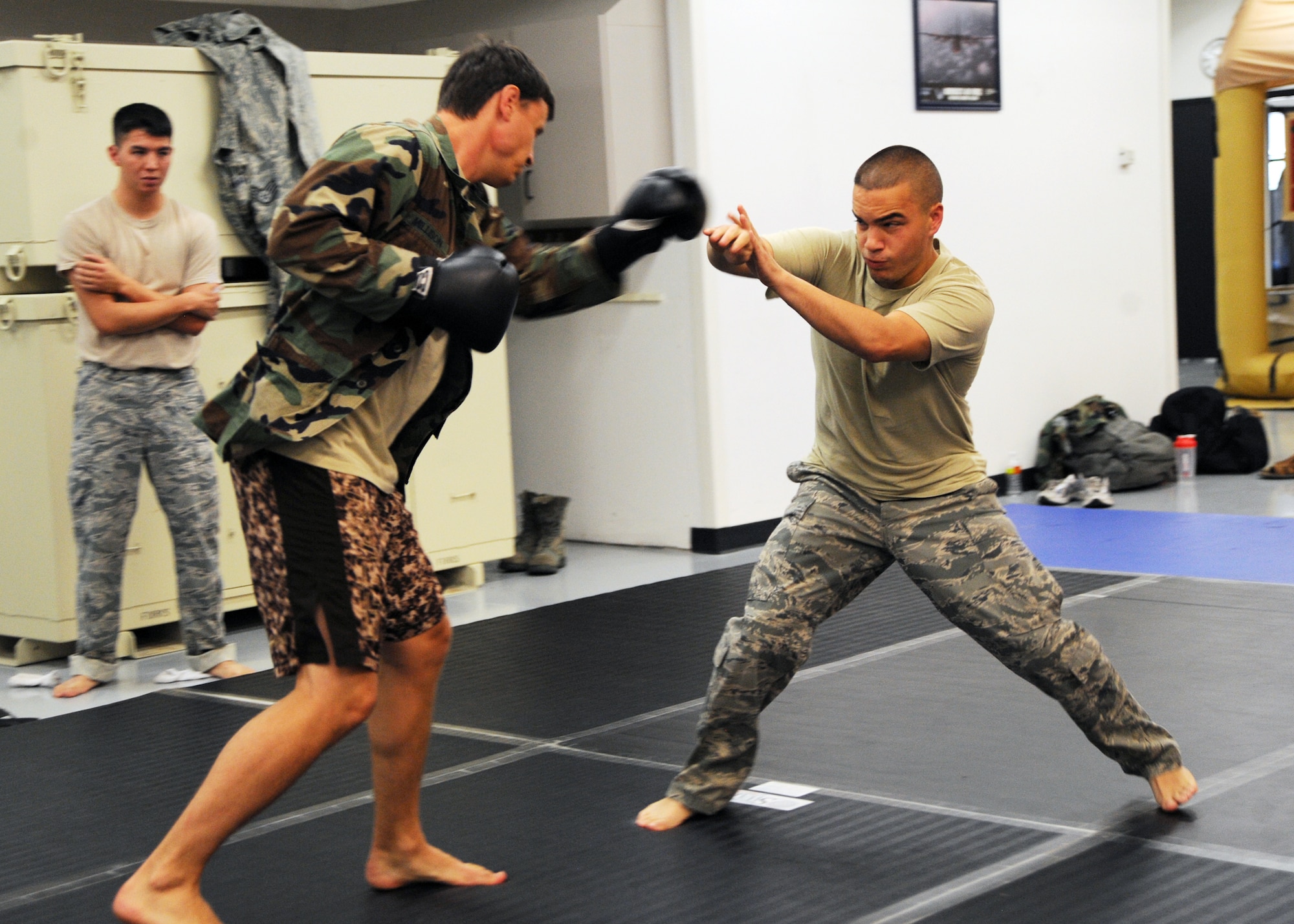 Airman 1st Class Jared Barlett, 22nd Operations Support Squadron aircrew flight equipment apprentice, blocks a punch from Staff Sgt. Charles Millison, 22nd OSS survival, evasion, resistance and escape specialist, during a combatives training course, July 22, 2010, McConnell Air Force Base, Kan.  Throughout the course, Airmen were educated with a basic set of unarmed combat skills to defend themselves in any given situation.  The course lasts five days and is held quarterly by Tech. Sgt. Joseph Rheaume and Staff Sgt. Charles Millison, McConnell’s SERE specialists.  (U.S. Air Force photo/Airman 1st Class Andrea Salazar)
