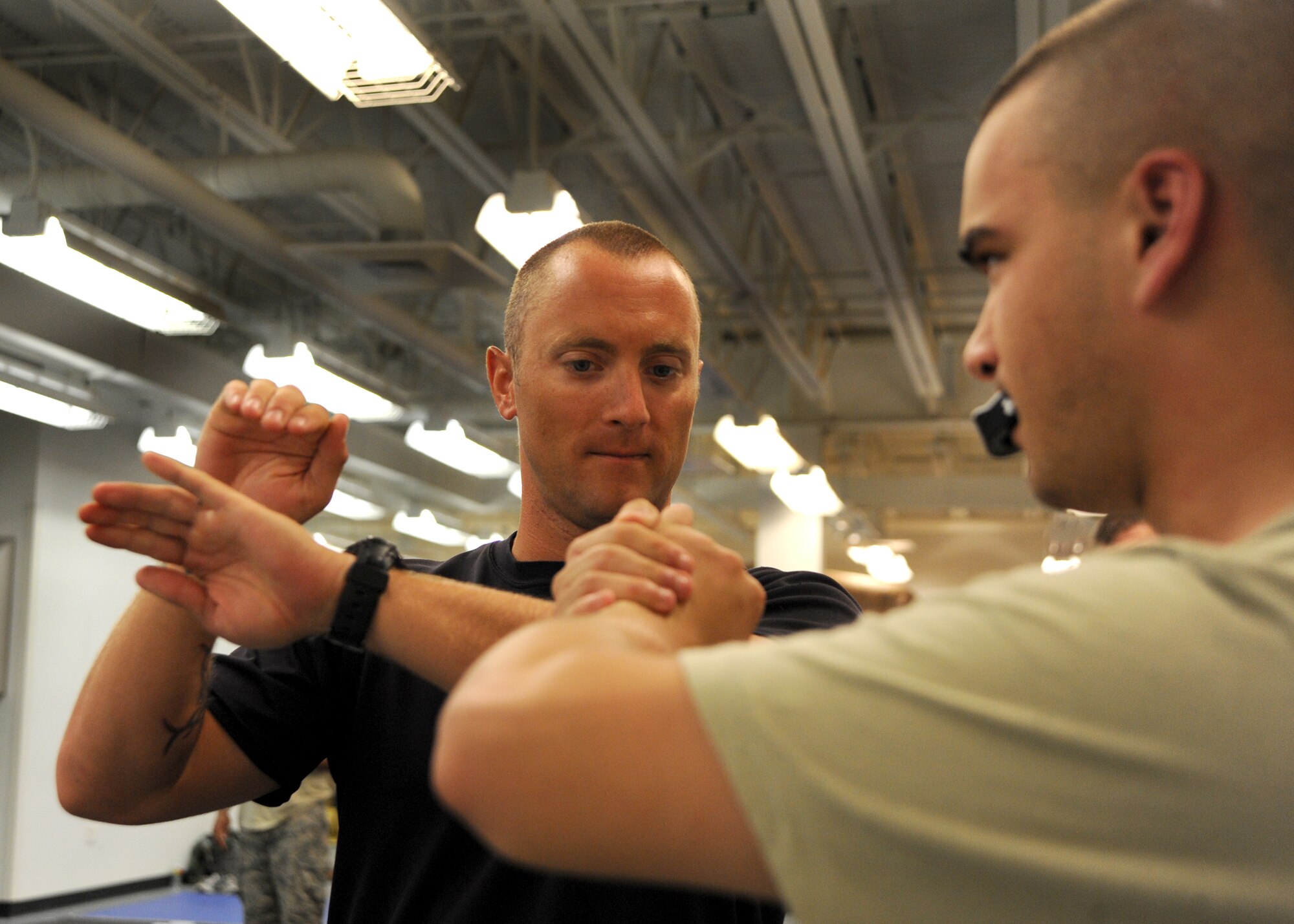 Tech. Sgt. Rheaume, 22nd Operations Support Squadron survival, evasion, resistance and escape specialist, teaches Airman 1st Class, Jared Barlett, 22nd OSS aircrew flight equipment apprentice, how to properly perform a submission hold during a Level 1 Modern Army Combatives training course, July 22, 2010, McConnell Air Force Base, Kan.  During the course, instructors help combatives students understand the techniques of what they are practicing and the logic behind them to maximize their power, speed and efficiency in any given situation.  The goal of the course is to build hand-to-hand combat abilities by teaching realistic combative training methods for battlefield Airmen.  (U.S. Air Force photo/Airman 1st Class Andrea Salazar)