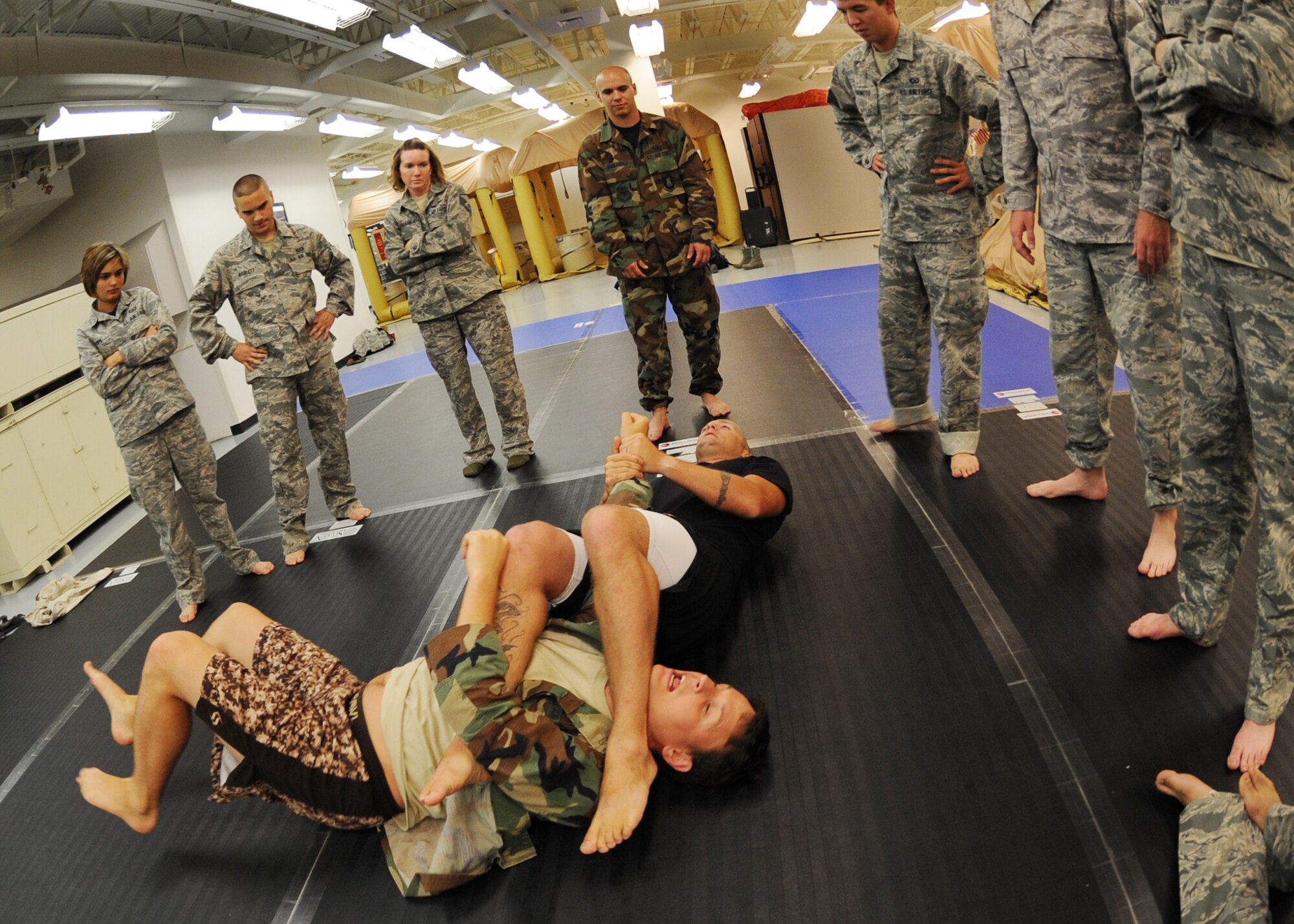 Tech. Sgt. Joseph Rheaume, 22nd Operations Support Squadron survival, evasion, resistance and escape specialist, demonstrates an arm-bar submission technique on Staff Sgt. Charles Millison, 22nd OSS SERE specialist, July 20, 2010, McConnell Air Force Base, Kan.  Sergeants Rheaume and Millison instruct a Level 1 Modern Army Combatives course that is targeted to Airmen deploying with U.S. Army forces.  The goal of the course is to build hand-to-hand combat abilities by teaching realistic combative training methods for battlefield Airmen.  For more information and enrollment, call 759-4915.  (U.S. Air Force photo/Airman 1st Class Andrea Salazar)
