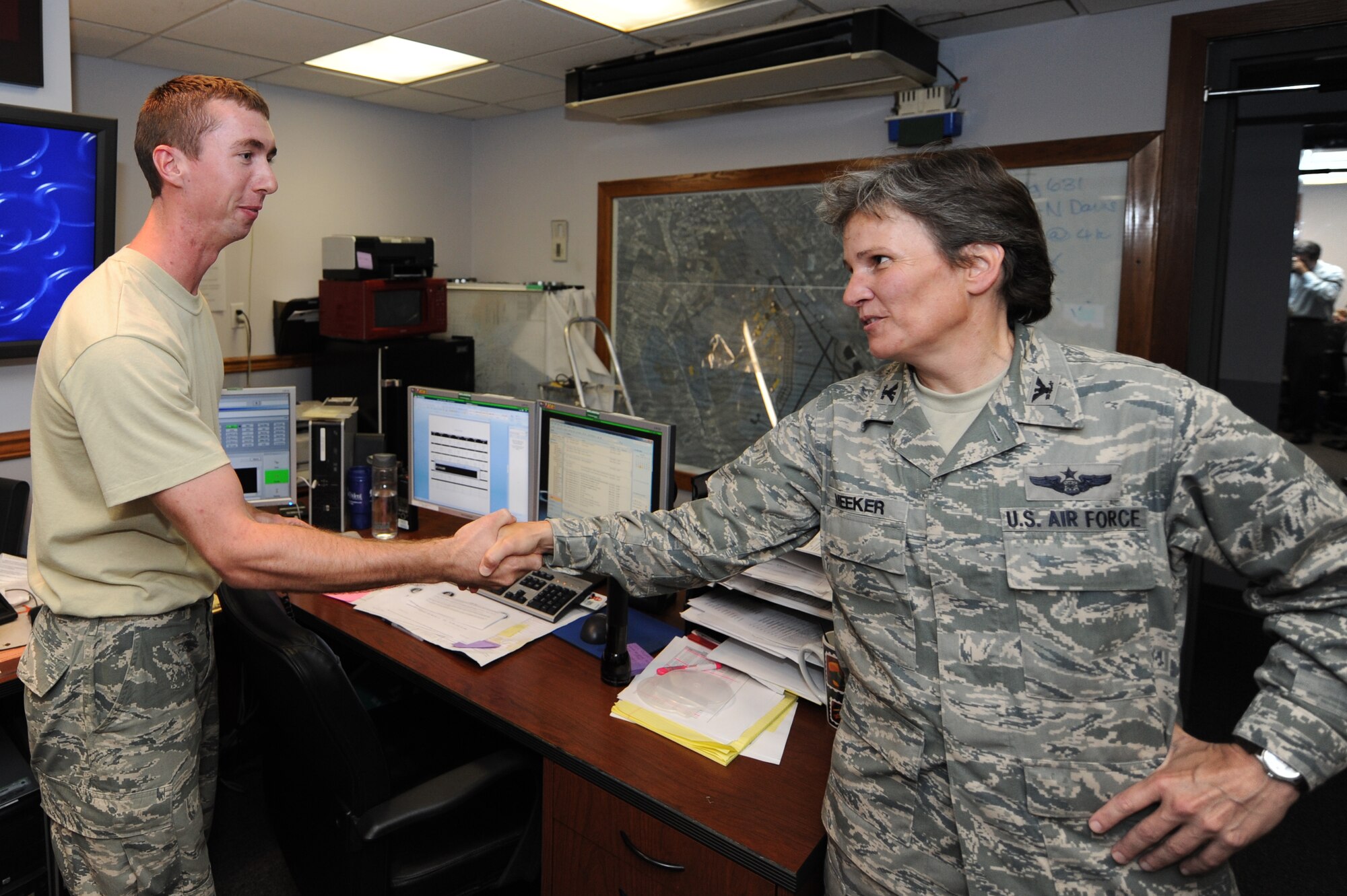 Col. Martha Meeker congratulates Senior Airman Samuel Siewert on being selected as one of the 12 Outstanding Airmen of the Year July 27, 2010, at Joint Base Charleston, S.C. Airman Siewert was selected for the first sergeants' Diamond Sharp Award and earned a Below-the-Zone promotion. He has also earned 15 credits toward his Community College of the Air Force degree and helped raise $1,000 for a South Carolina children's charity. Colonel Meeker is the commander of Joint Base Charleston and Airman Siewert is a fire protection journeyman with the 628th Civil Engineer Squadron. (U.S. Air Force photo/James M. Bowman)
