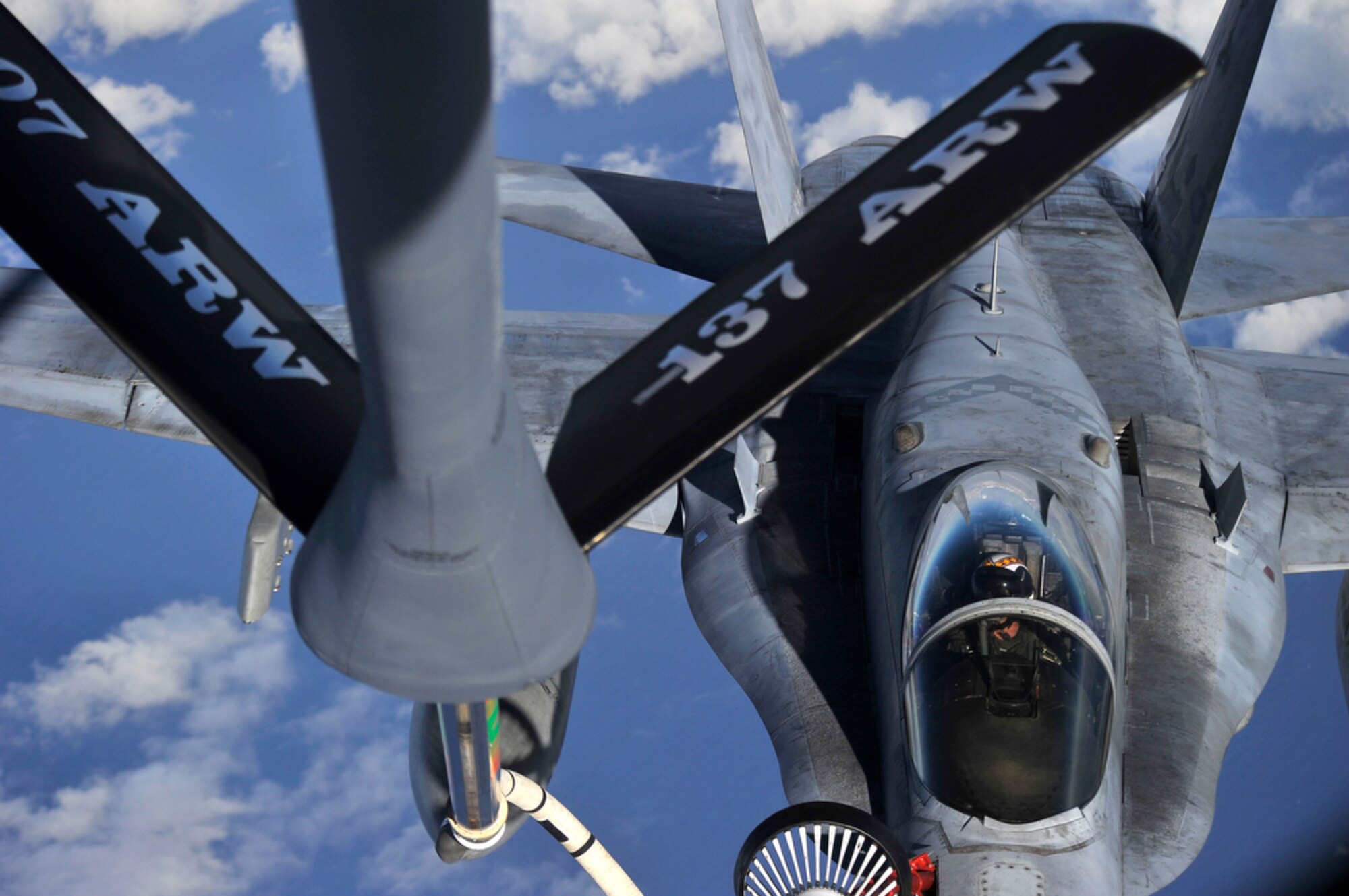 JOINT BASE PEARL HARBOR-HICKAM, Hawaii - A U.S. Navy F/A-18 Super Hornet fighter receives fuel from a KC-135 Stratotanker that is assigned to the 465th Air Refueling Squadron, 507th Air Refueling Wing, Tinker Air Force Base, Okla., while over Hawaiian air space during the Rim of the Pacific Exercise on July 20. RIMPAC, the world's largest maritime exercise is a biennial event which stresses interoperability of all partner nations as a key element of regional stability. There are 14 nations, 32 ships, five submarines, more than 170 aircraft and 20,000 personnel involved here in this exercise.   (U.S.  Air Force photo/Tech Sgt. Cohen A. Young)