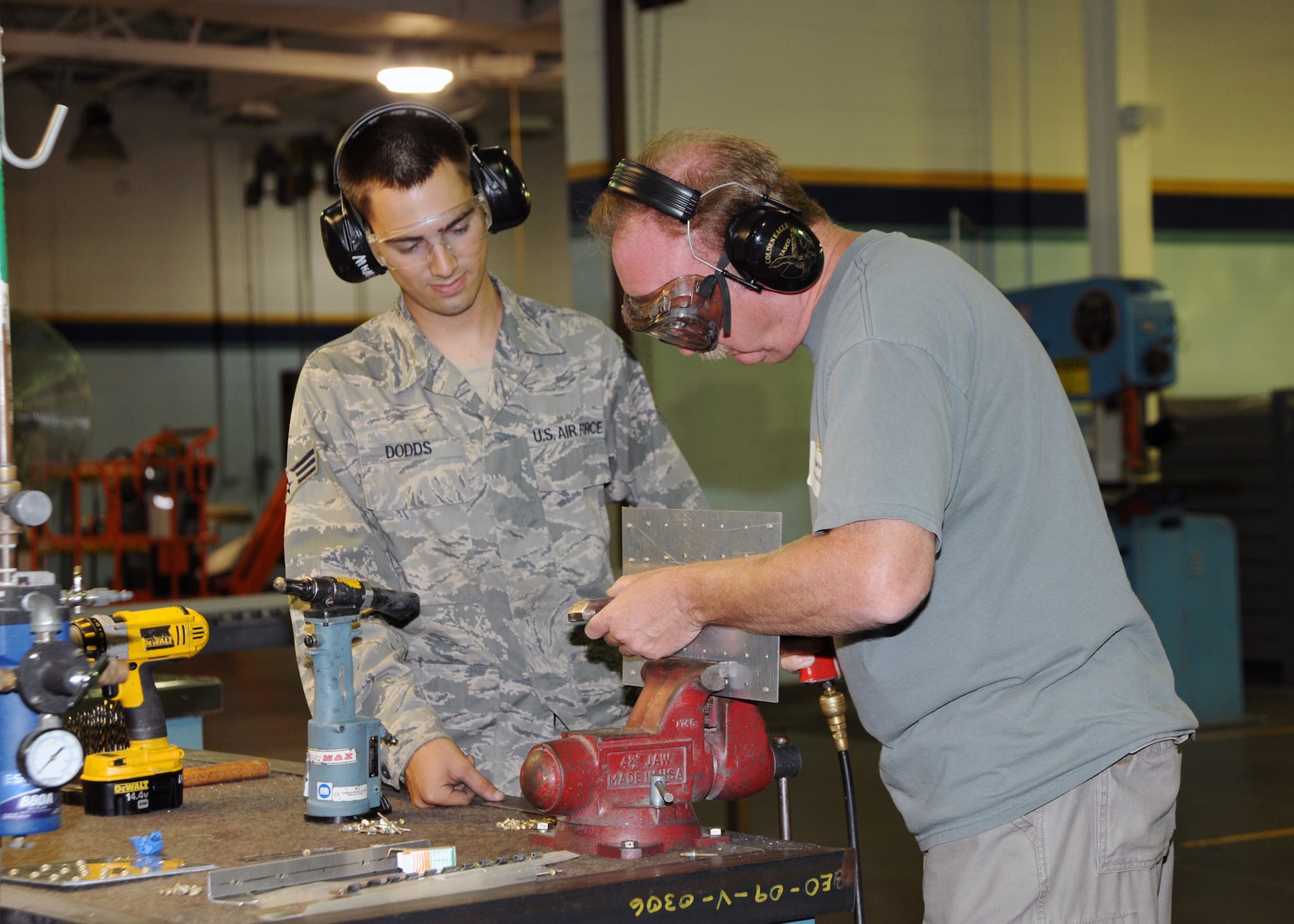 Senior Airman Gregory Dodds, 22nd Maintenance Squadron aircraft structural maintenance journeyman, shows Lt. Sam Hanley, Wichita Police Department and McConnell honorary commander, how to replace rivets during a quarterly honorary commander orientation tour inside Building 1169, July 22, 2010, McConnell Air Force Base, Kan.  This quarter, the 22nd Maintenance Group hosted the tour. Honorary commanders are local community partners who are paired with each unit commander for a year or more and learn more about McConnell’s mission, assets and programs.  (U.S. Air Force photo/Airman 1st Class Andrea Salazar)