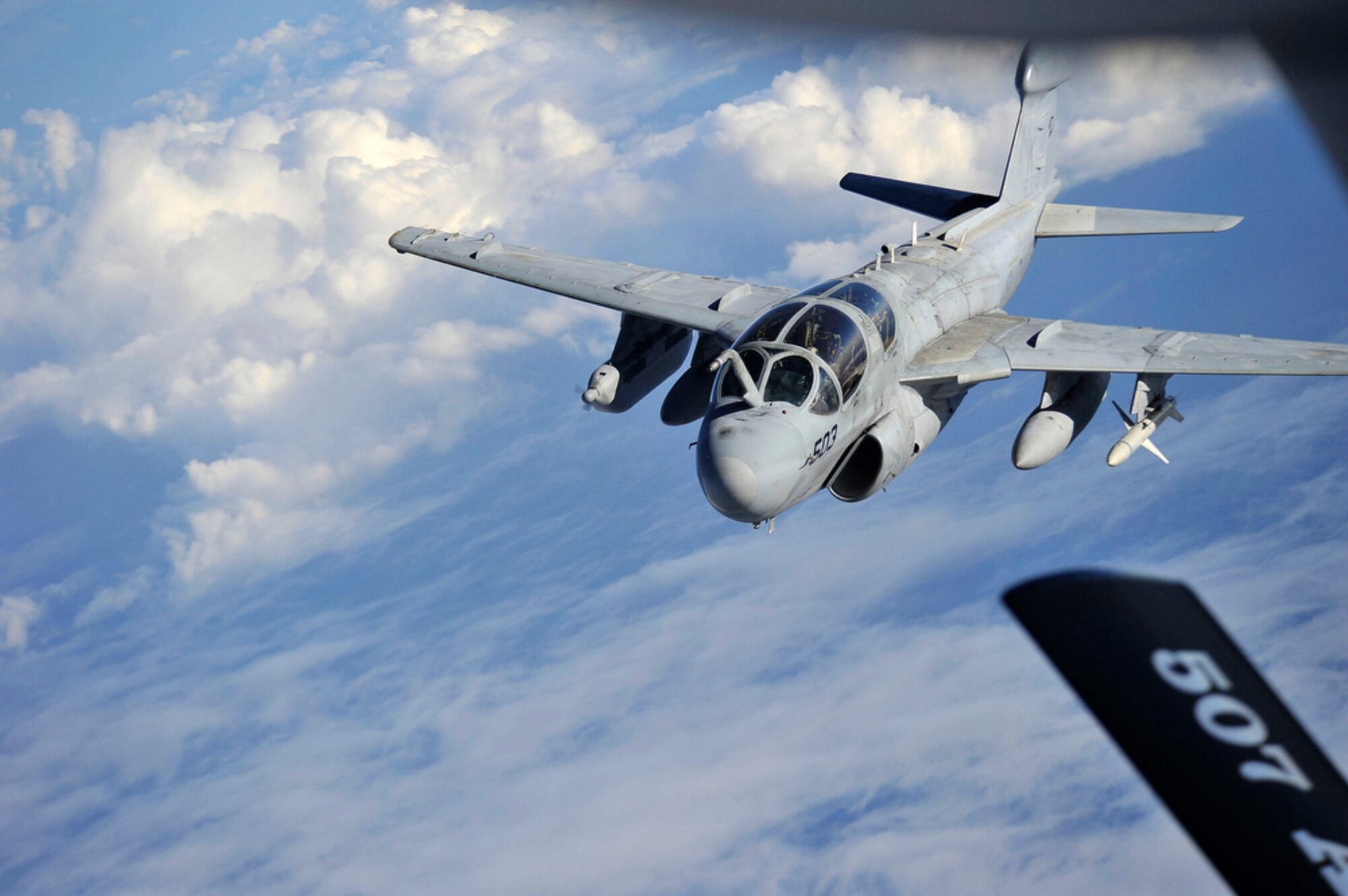 JOINT BASE PEARL HARBOR-HICKAM, Hawaii - An U.S. Navy EA-6 Prowler drifts away from a KC-135 Stratotanker assigned to the 465th Air Refueling Squadron, 507th Air Refueling Wing, Tinker Air Force Base, Okla., after being refueled over Hawaiian air space during the Rim of the Pacific Exercise on July 20. RIMPAC, the world's largest maritime exercise is a biennial event which stresses interoperability of all partner nations as a key element of regional stability. There are 14 nations, 32 ships, five submarines, more than 170 aircraft and 20,000 personnel involved here in this exercise.   (U.S.  Air Force photo/Tech Sgt. Cohen A. Young)
