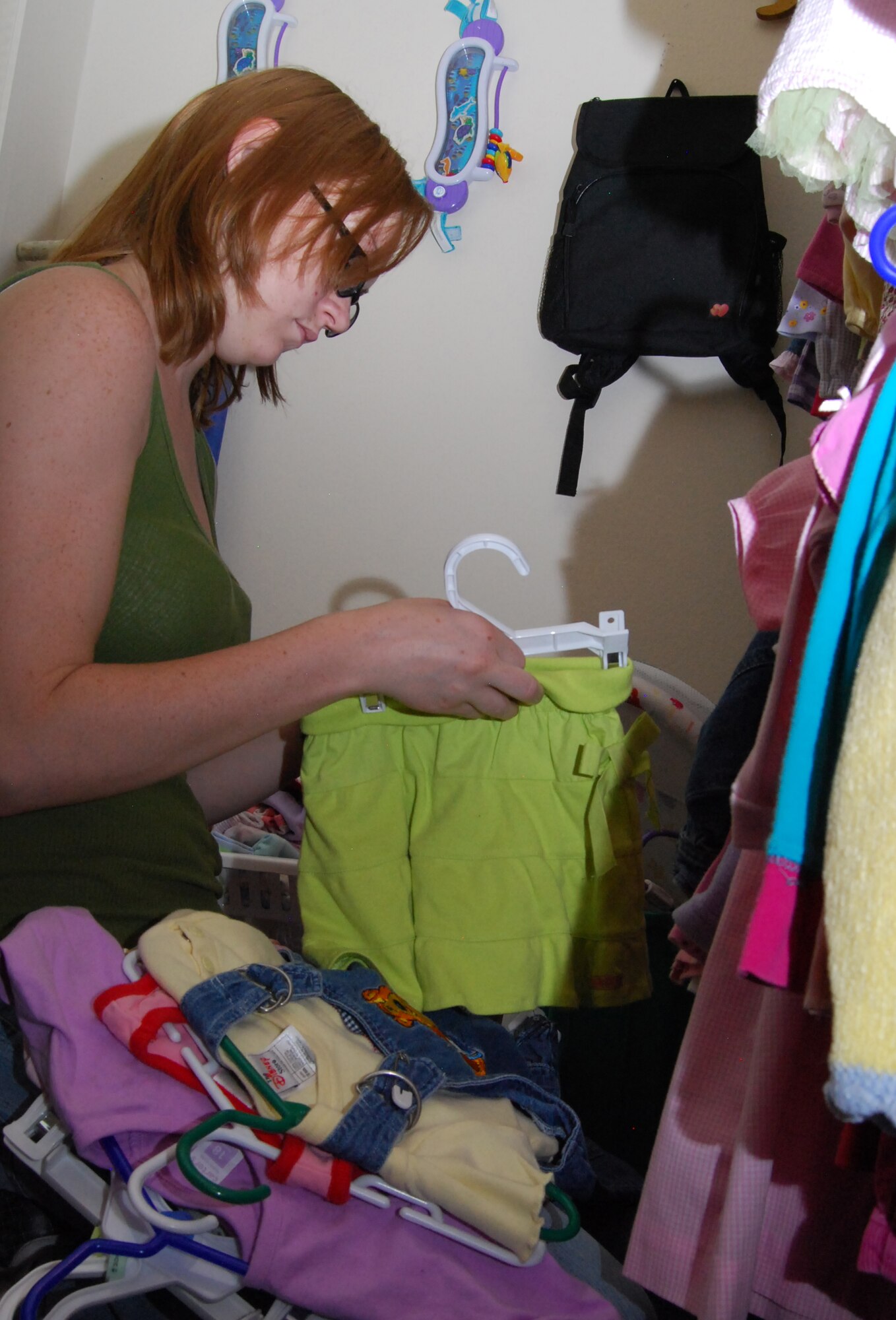 Jaime Gaines looks through clothing for her 14-month-old daughter, Jordan, during a grand reopening ceremony for the Airman's Attic at the Air Force Academy July 27, 2010. Mrs. Gaines lives with her husband, Army Pfc. Jesse Gaines, in Douglass Valley Housing at the Academy in Colorado Springs, Colo. Private Gaines is assigned to Fort Carson. (U.S. Air Force photo/Staff Sgt. Don Branum)
