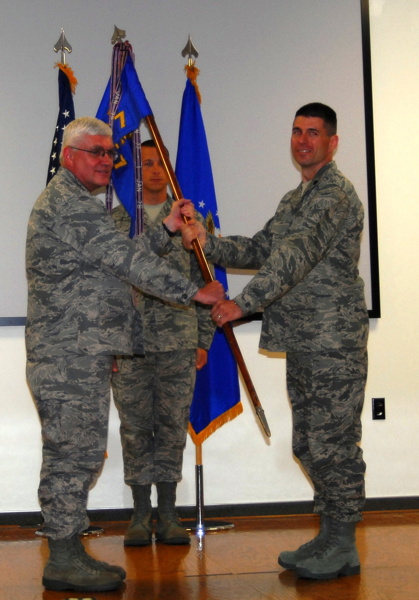 Left foreground, Col. Daniel P. Morin, Air Force Research Laboratory vice commander hands the AFRL Propulsion Directorate Detachment 7 guidon to Lt. Col. Michael H. Platt during a formal Air Force appointment to command ceremony.  Master Sgt. Carlos E. Labrador, AFRL Det. 7 Acting First Sergeant, standsby to receive the guidon from Col. Platt for posting next to the Air Force service flag.  (Air Force photograph by Stephen K. Robinson)