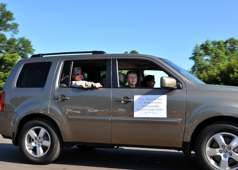MINOT, N.D. -- Col. Fred Stoss, 91st Missile Wing commander, waves to the crowd during the North Dakota State Fair parade here July 24. Col. Doug Cox, 5th Bomb Wing commander, also participated in the parade. The 2010 North Dakota State Fair is open to the public until July 31. (U.S. Air Force photo by Senior Airman Michael J. Veloz)