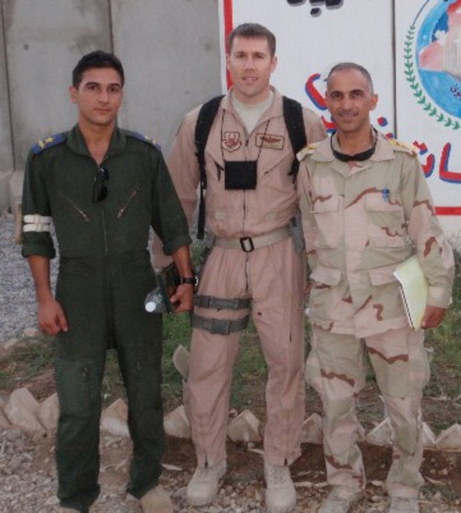 Maj. James West, 69th Fighter Squadron instructor pilot, center, stands with his Iraqi counterparts outside the Mosul Operations Center, Iraq. Major West was deployed to Baghdad, Iraq as an air advisor to the Iraqi National Counter Terrorism Forces from July 2008 to January 2009. Major West wrote a research thesis about his experiences as an air advisor and was recently selected as the Culture Studies Research award winner at Air Command and Staff College. (Courtesy photo)