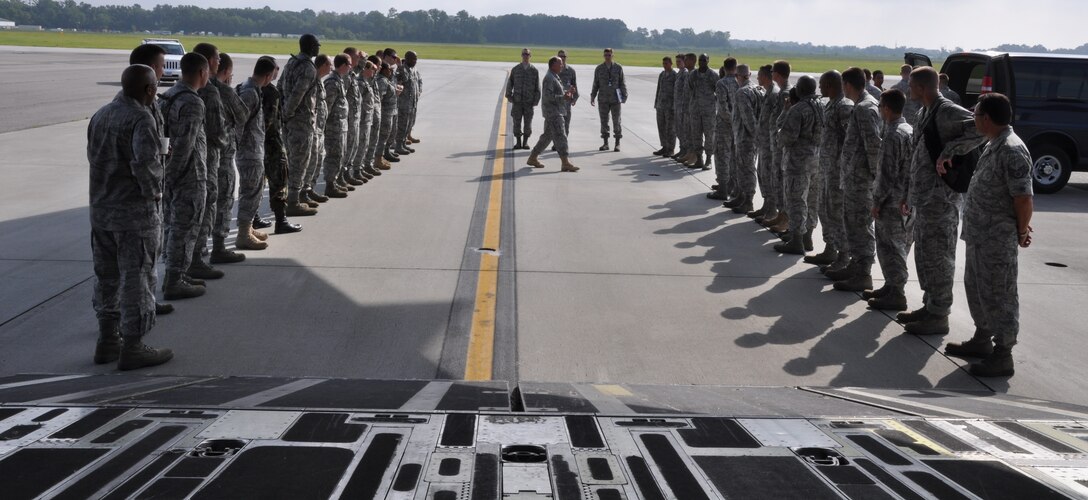 Chaplain (Lt. Col.) Carl Yost instructs 30 chaplain candidates on casualty ramp ceremony formation protocol here July 27. Chaplain Yost is a 315th Airlift Wing chaplain, and the chaplain candidates are with the Air Force Chaplain Candidate Intensive Internship Program. (U.S. Air Force photo/Staff Sgt. Shane Ellis)