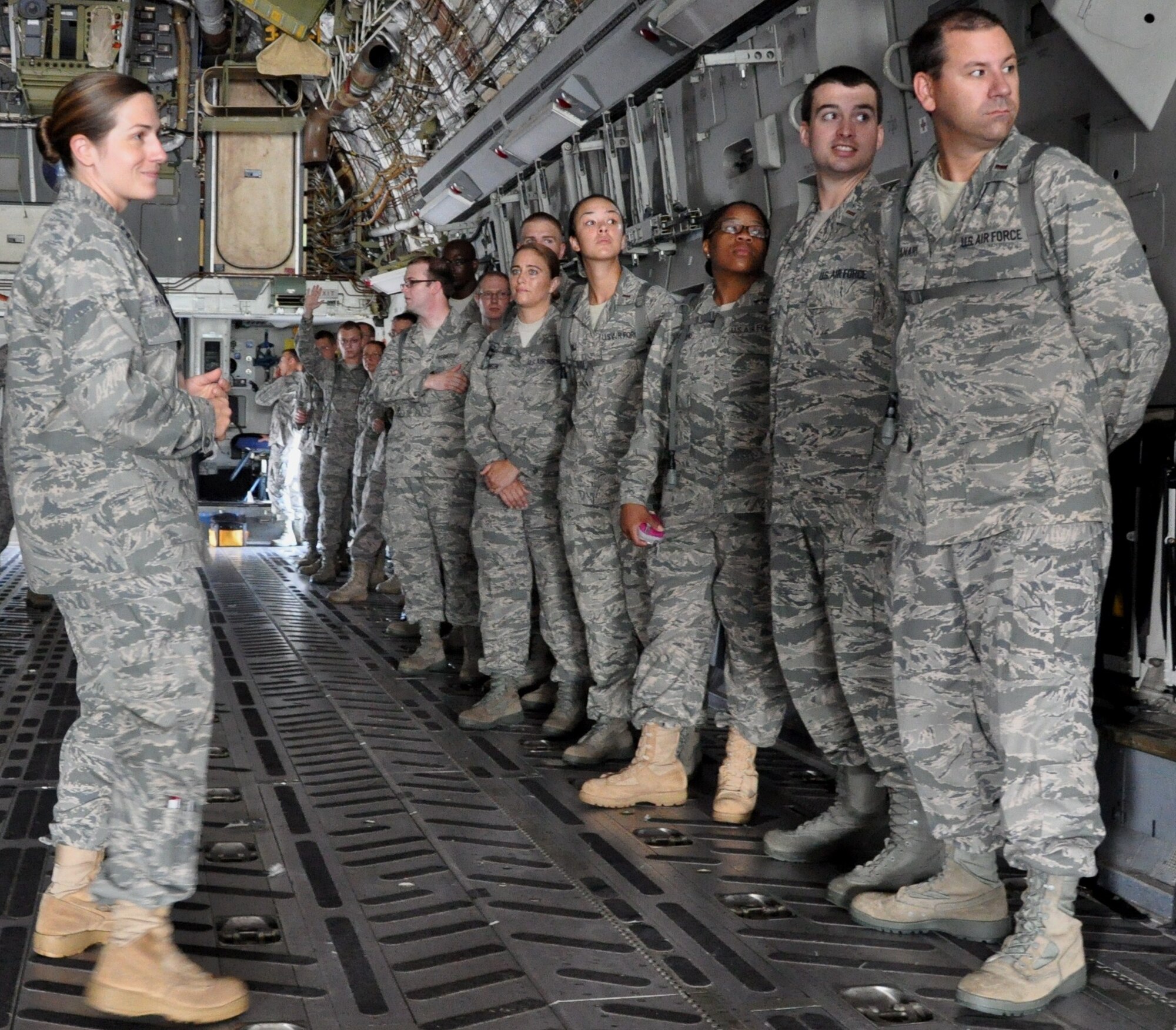 Capt. Tabitha H. Rand speaks to 30 chaplain candidates about the mission of the C-17 Globemaster III and the aircraft maintainers responsibilities during a casualty ramp ceremony here July 27. Capt. Rand is a 315th Airlift Wing maintenance officer, and the chaplain candidates are with the Air Force Chaplain Candidate Intensive Internship Program. (U.S. Air Force photo/Staff Sgt. Shane Ellis)