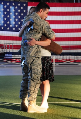 ELLSWORTH AIR FORCE BASE, S.D. -- Staff Sgt. George Munoz, 28th Munitions Squadron armament maintainer, hugs his wife Christan after returning from a deployment, July 28. More than 190 Airmen returned from a deployment in Southwest Asia and were greeted by friends and family. (U.S Air Force photo/Airman 1st Class Anthony Sanchelli) 