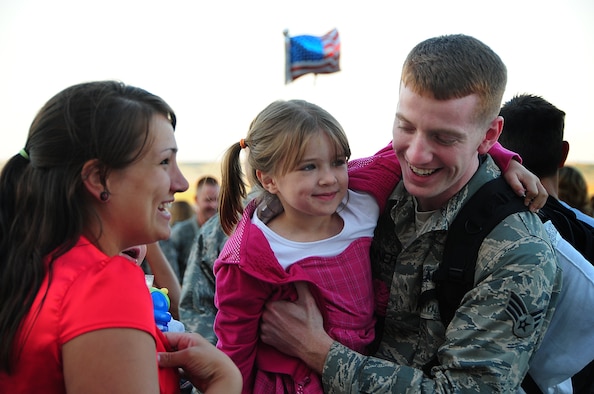 ELLSWORTH AIR FORCE BASE, S.D. -- Senior Airman David Benner, 28th Munitions Squadron conventional munitions maintainer, is reunited with his wife Kristy and his daughter Josie after a deployment in Southwest Asia, July 28. More than 190 Airmen were greeted by friends, family and co-workers. (U.S Air Force photo/Airman 1st Class Anthony Sanchelli) 