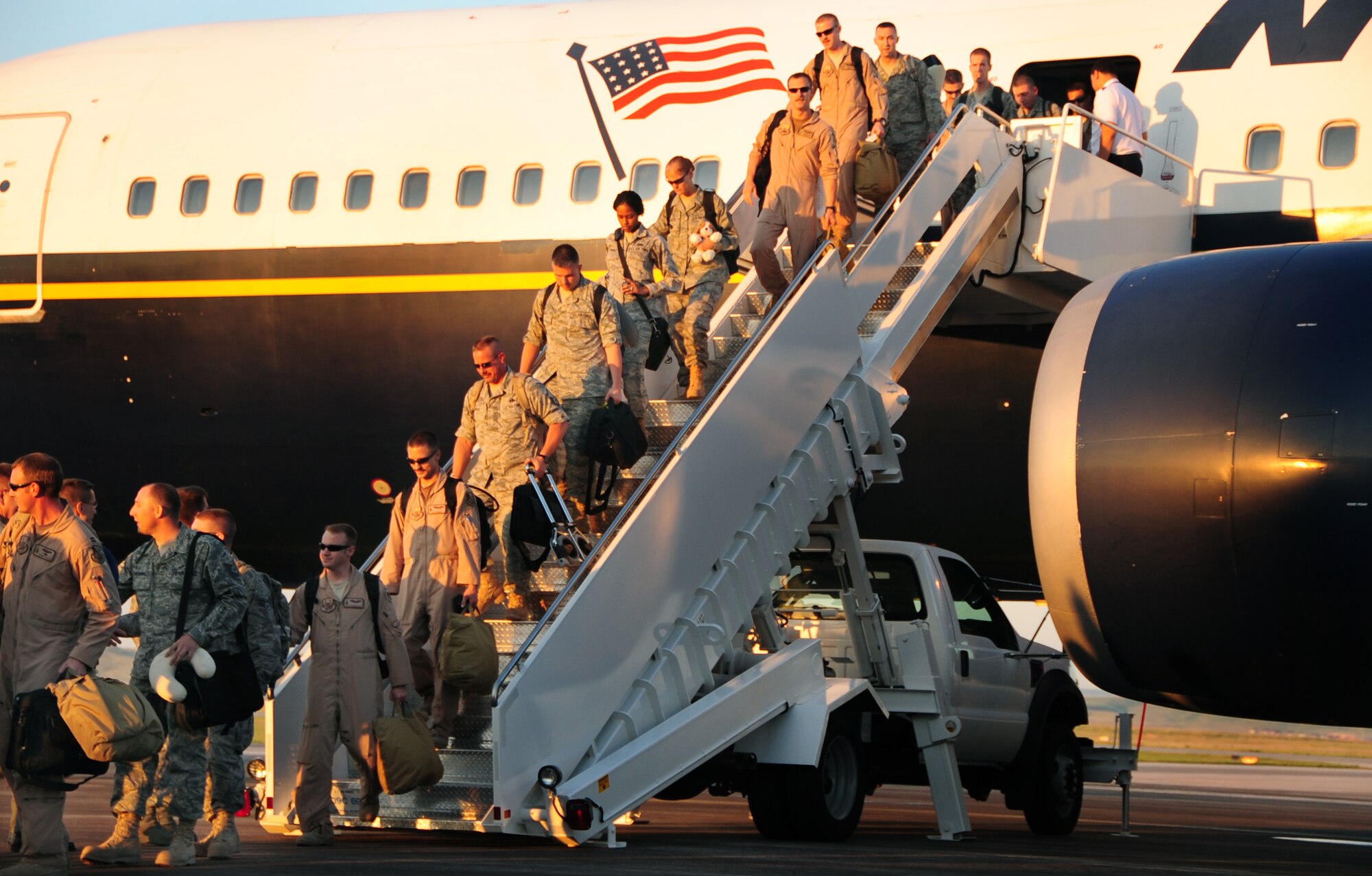 ELLSWORTH AIR FORCE BASE, S.D. -- Airmen step off a Boeing 767 after returning from a 6–month deployment and are greeted by Col. Steven Hiss, 28th Bomb Wing vice commander , July 28.  Airmen were reunited with friends, family and co-workers this morning. (U.S Air Force photo/Airman 1st Class Anthony Sanchelli)