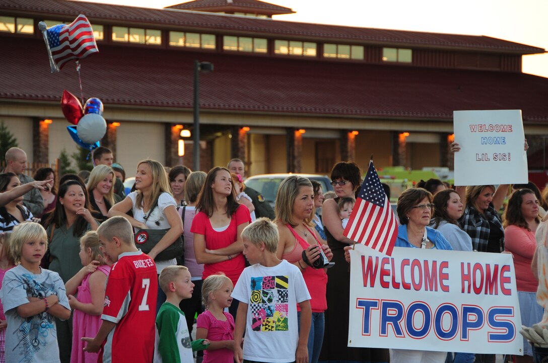 ELLSWORTH AIR FORCE BASE, S.D. -- Friends and family members of deployed Airmen stand outside the PRIDE Hangar before the Airmen step off the plane, July 28. More than 350 Airmen from the 34th Bomb Squadron, 28th Aircraft Maintenance Squadron, Munitions Squadron, Operational Support squadron, Logistic Readiness Squadron and Maintenance Squadron are scheduled to return home from Southwest Asia today. (U.S Air Force photo/Airman 1st Class Anthony Sanchelli)
