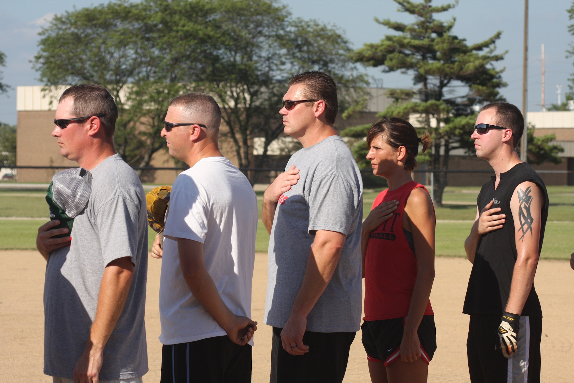 WRIGHT-PATTERSON AIR FORCE BASE, Ohio – Reservists from the 445th Airlift Wing cover their hearts while the National Anthem is playing at the third annual Air Force Sergeants Association Active Duty vs. Reserves Softball Challenge July 24. (U.S. Air Force photo/Senior Airman Robert Nelson)